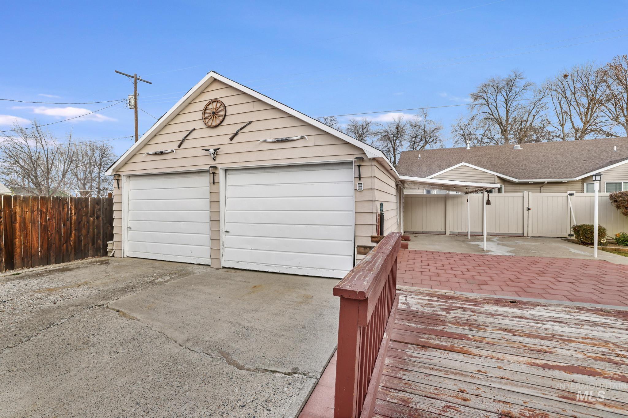 Garage featuring a gate and concrete driveway