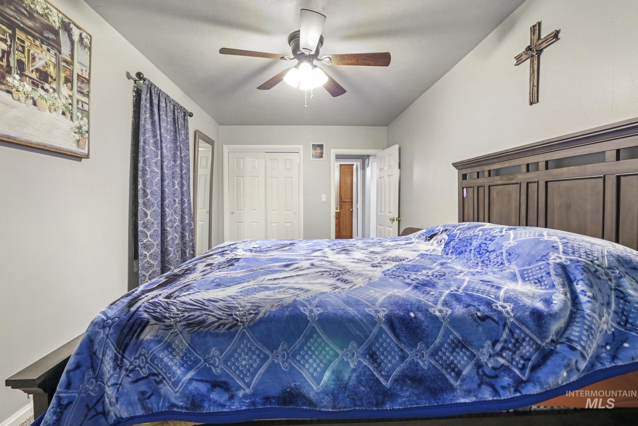 Bedroom with a ceiling fan and a closet
