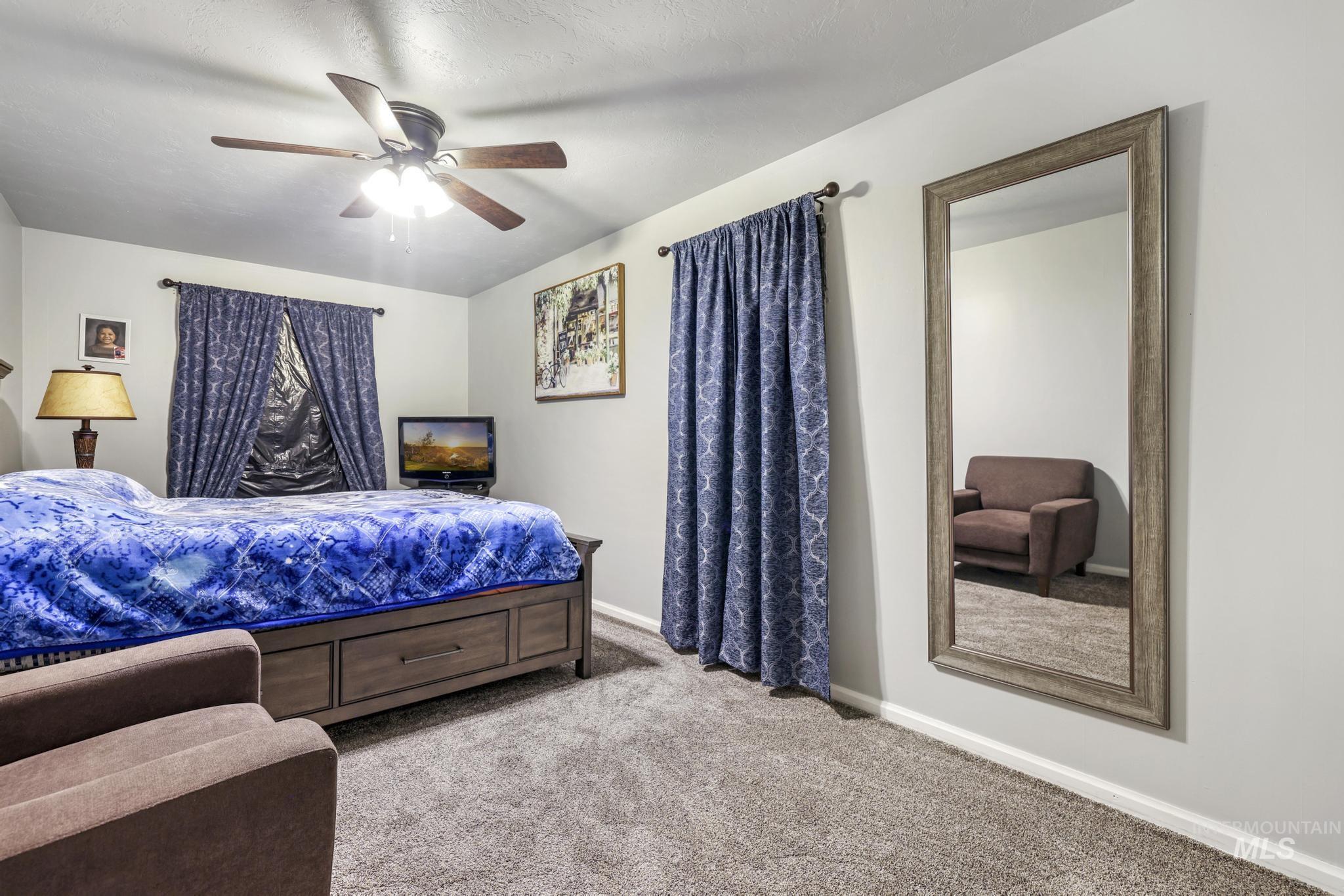 Bedroom featuring light carpet and ceiling fan