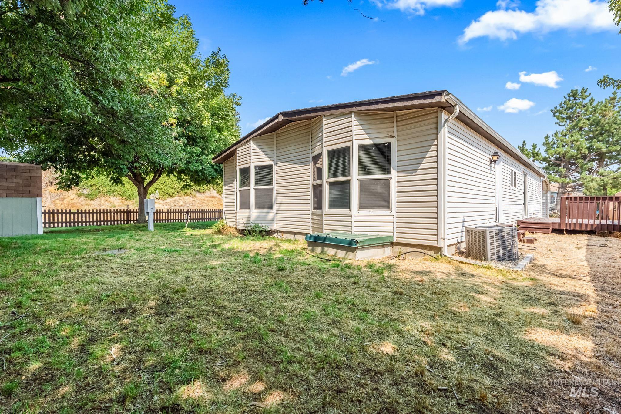 View of property exterior featuring a wooden deck and a cooling unit