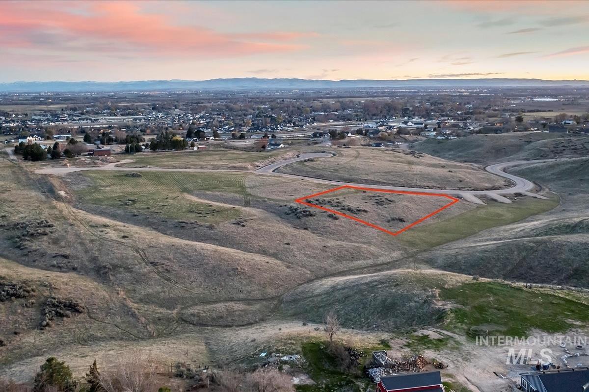 Aerial view at dusk of property boundaries highlighted and a mountain view