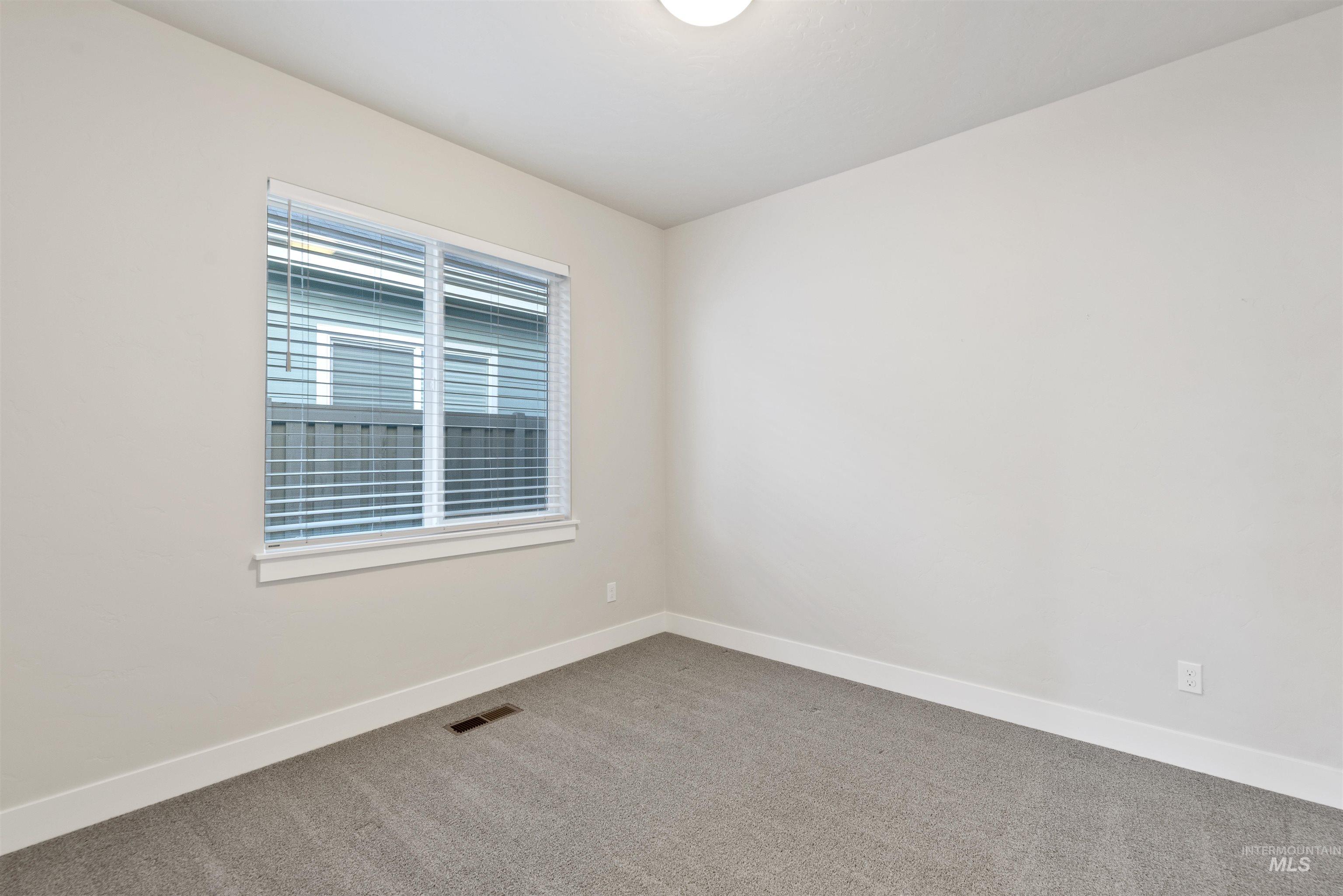Unfurnished room with baseboards and carpet flooring