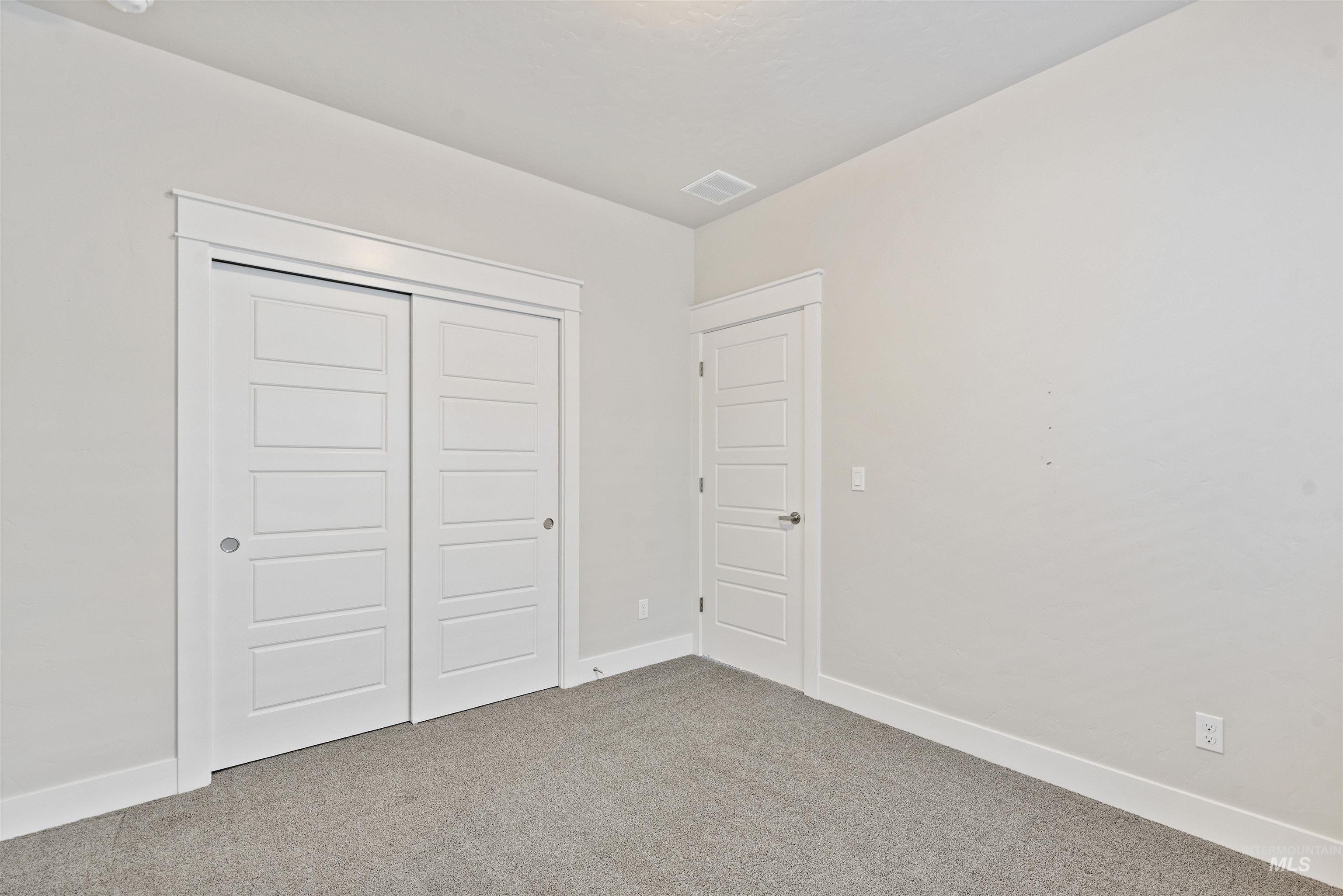 Unfurnished bedroom featuring a closet and carpet floors