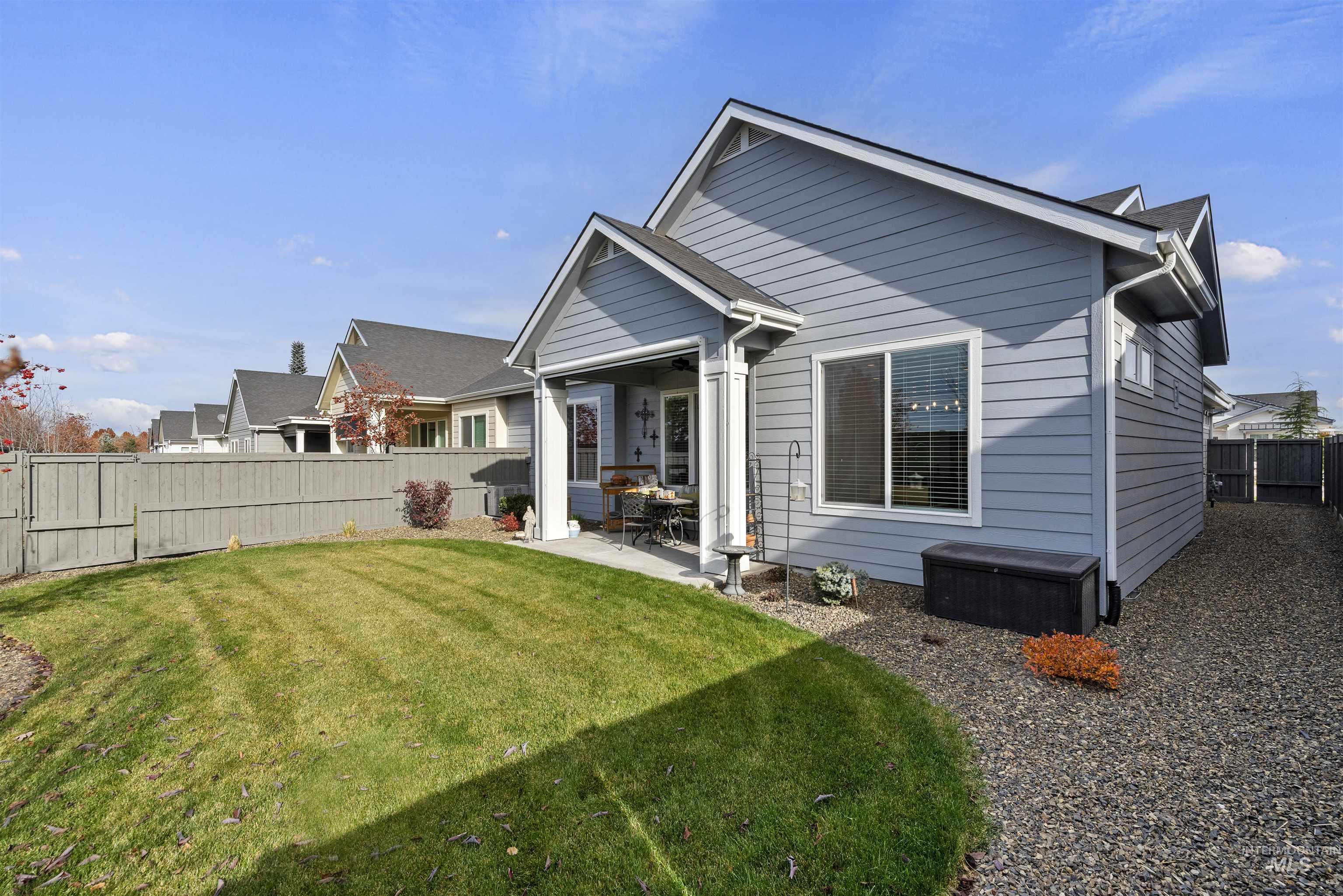 Back of property featuring a fenced backyard and a patio