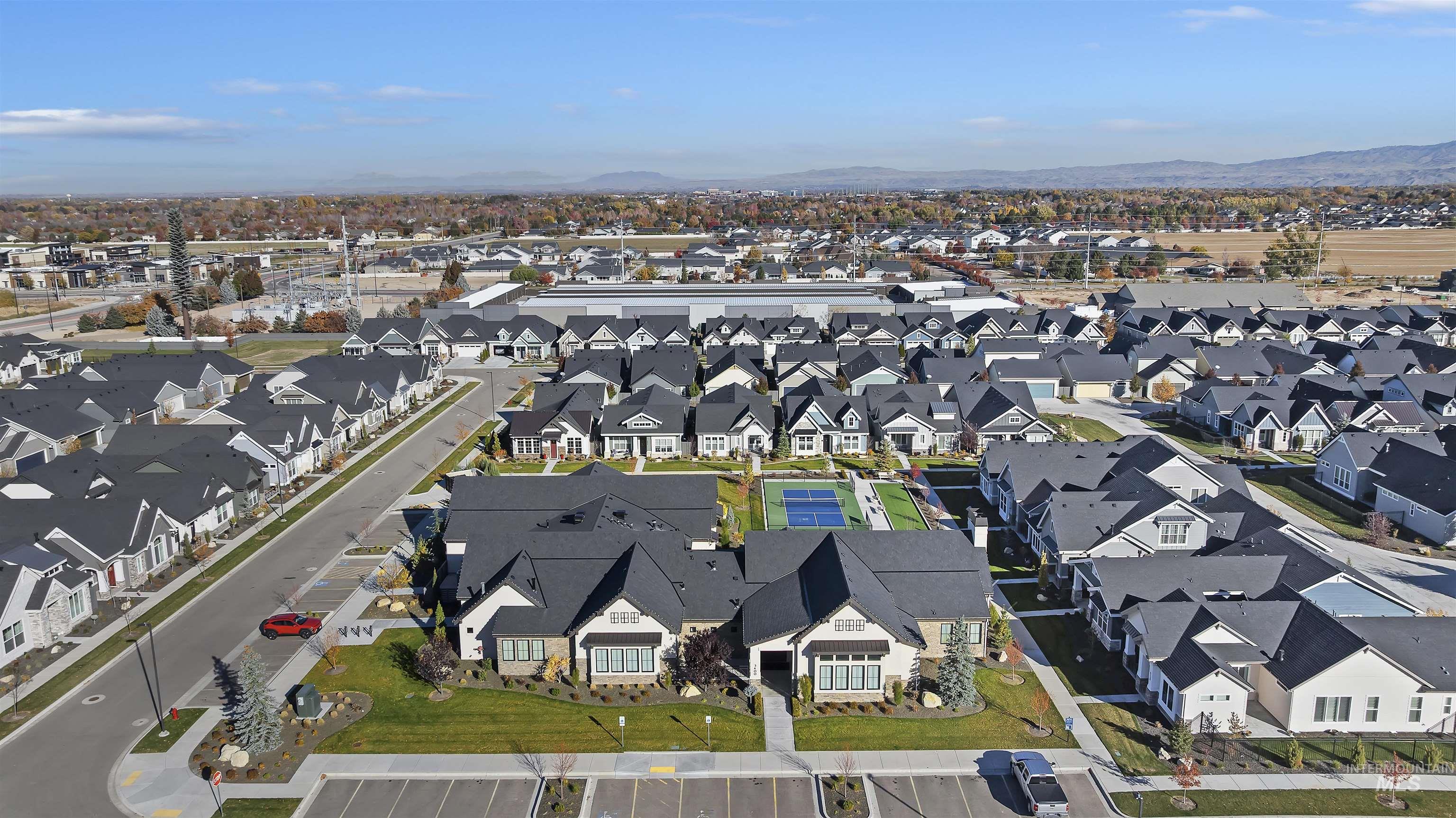 Aerial view of property's location with a mountain backdrop and nearby suburban area