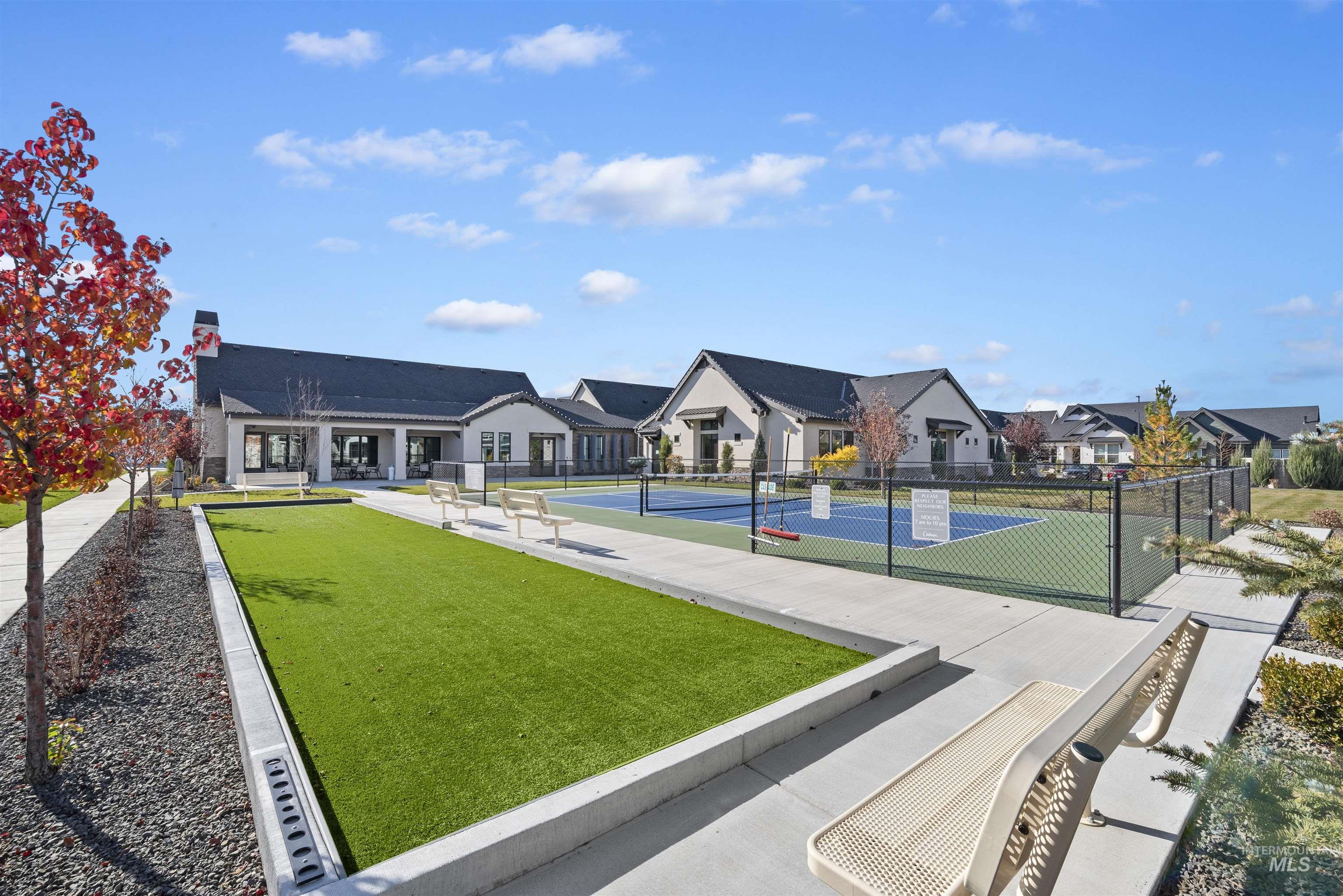 View of community with a tennis court, a residential view, and a bocce ball area