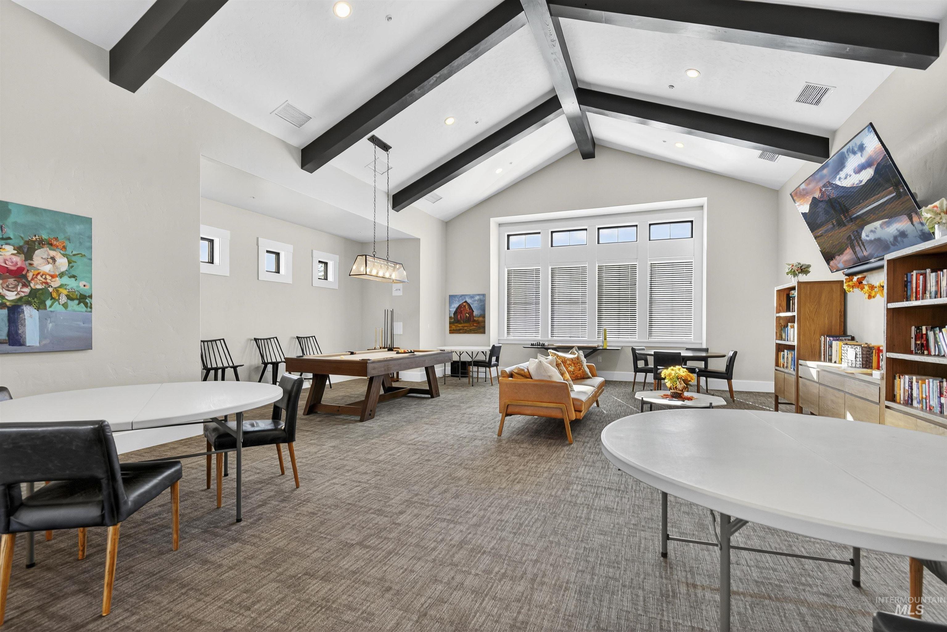 Carpeted living room featuring beamed ceiling, recessed lighting, and high vaulted ceiling