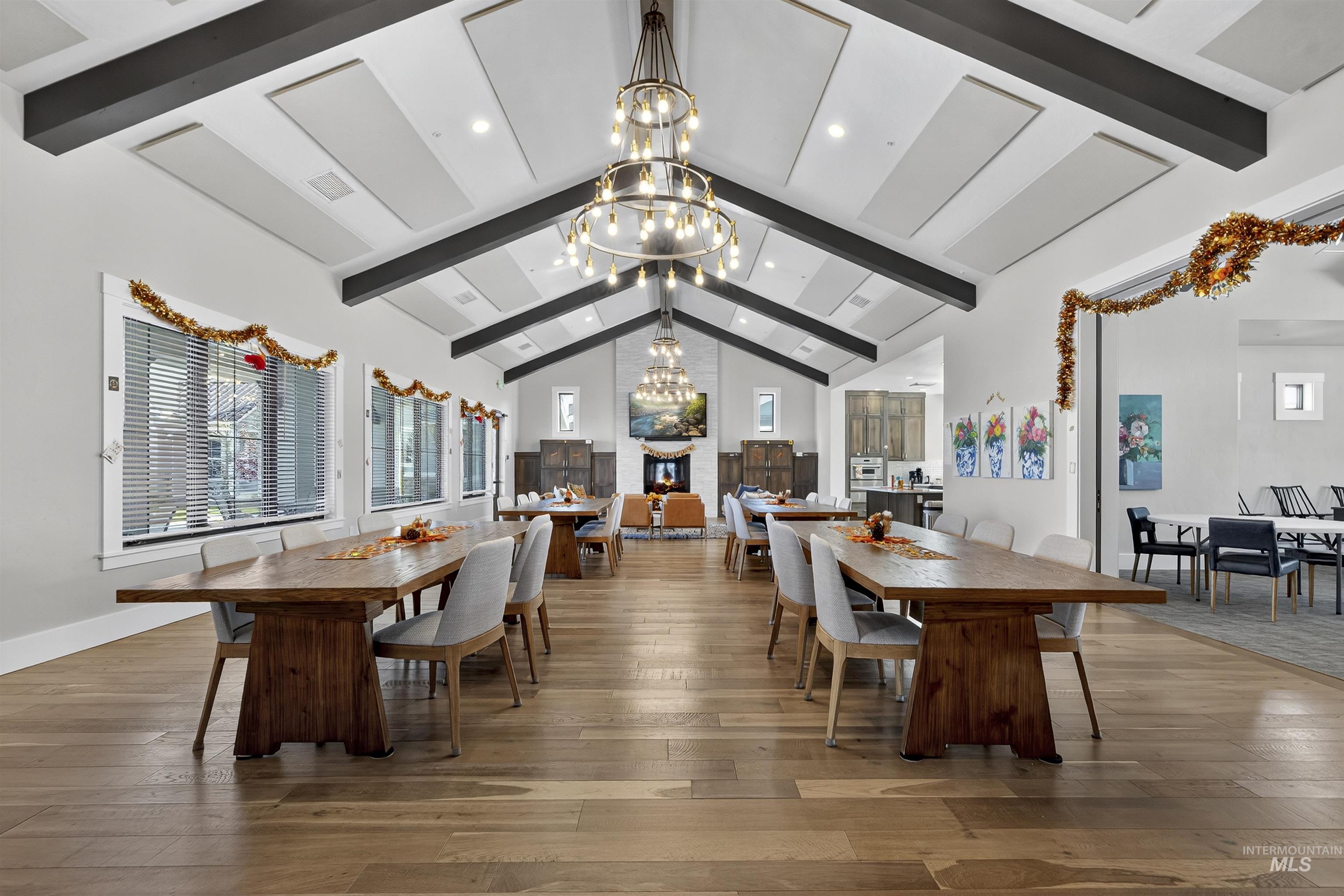 Dining room featuring beam ceiling, a chandelier, light wood-style floors, high vaulted ceiling, and recessed lighting