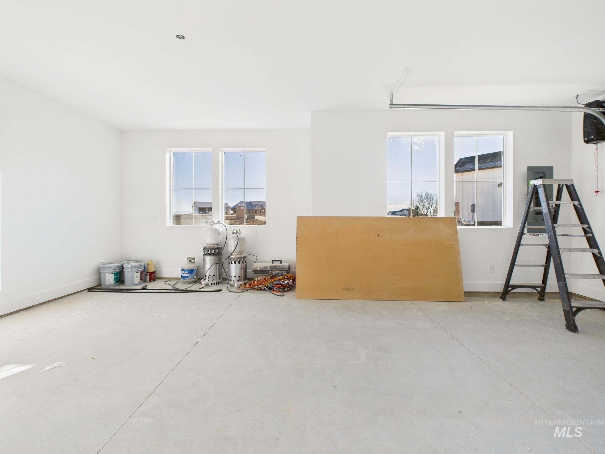 Unfurnished room featuring concrete flooring