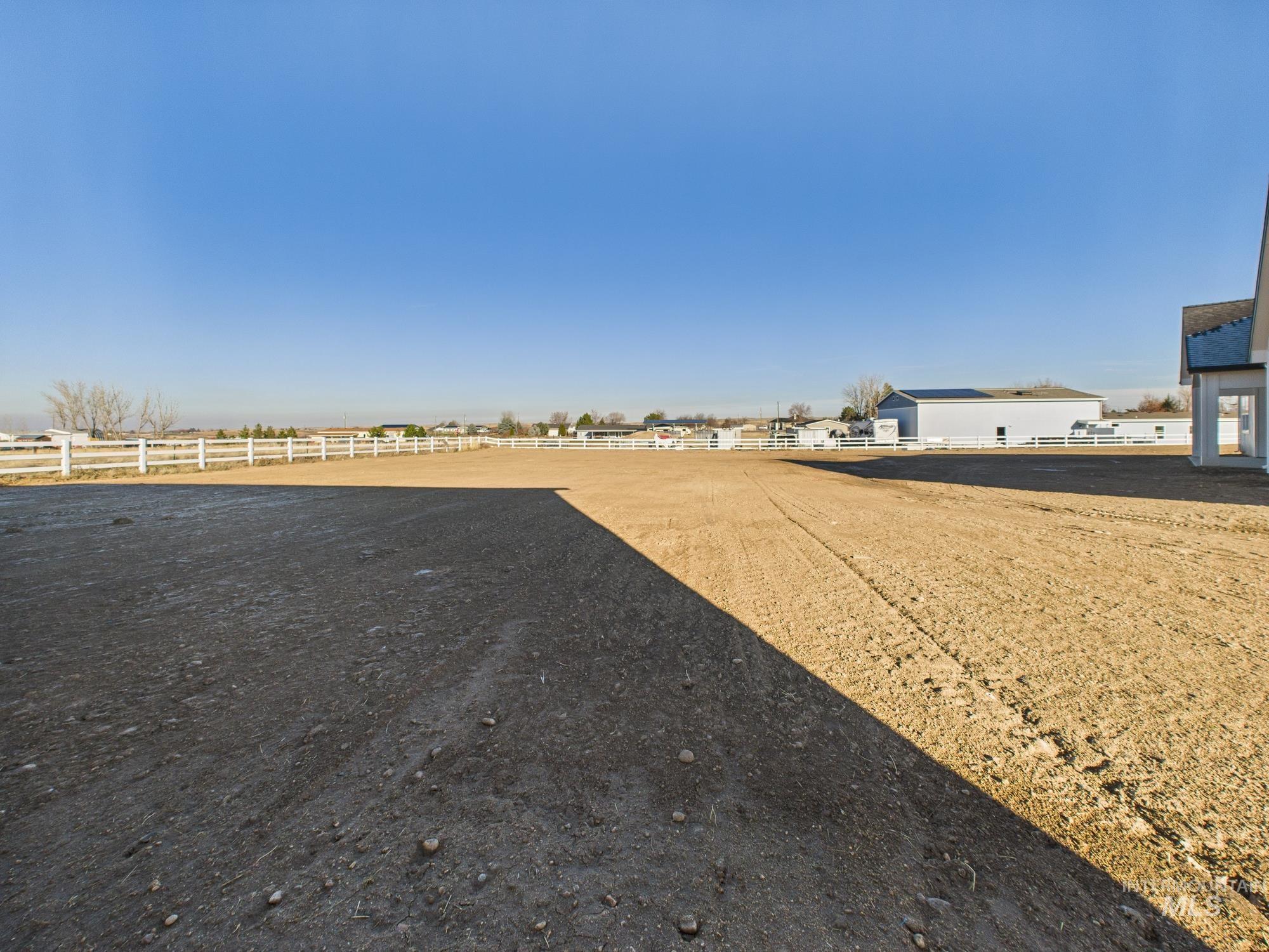 View of yard featuring an enclosed riding area and a view of rural / pastoral area