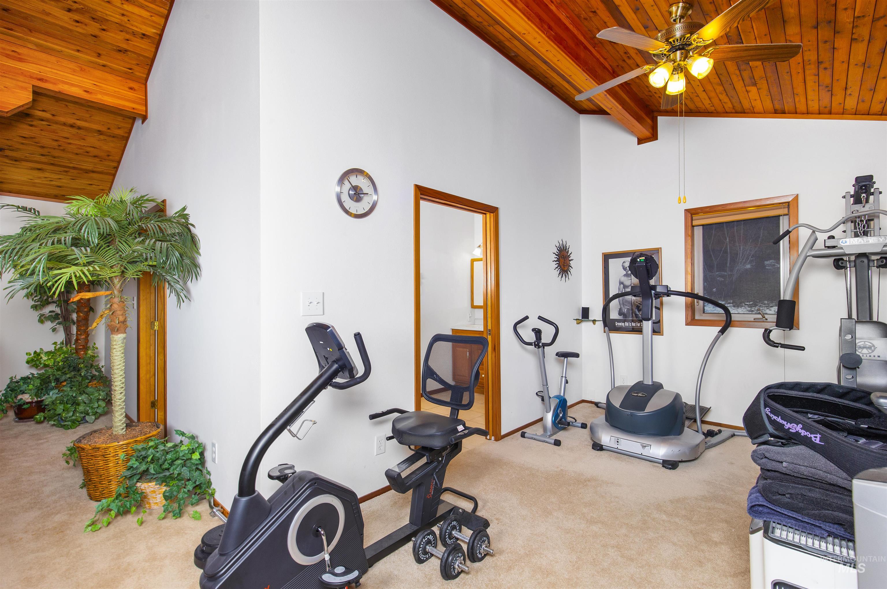 Bonus room with a wood ceiling with exposed beams, carpet floors, ceiling fan, and high vaulted ceiling