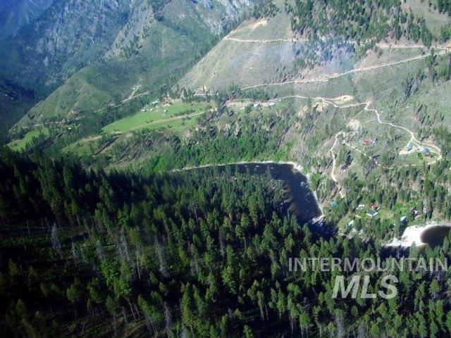 Aerial view of property and surrounding area with a heavily wooded area and mountains