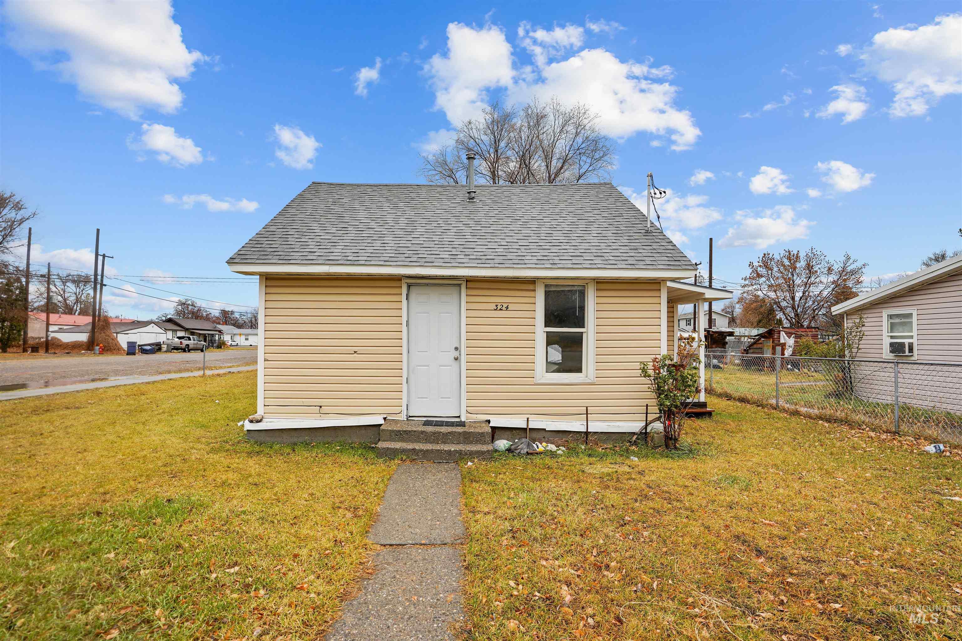 Bungalow-style house with a shingled roof and entry steps