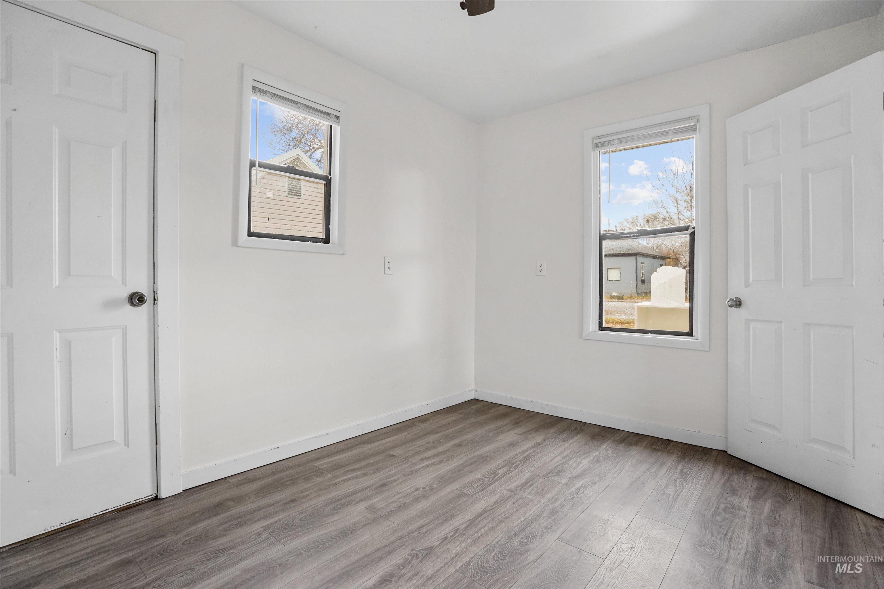 Unfurnished bedroom with wood finished floors and a ceiling fan