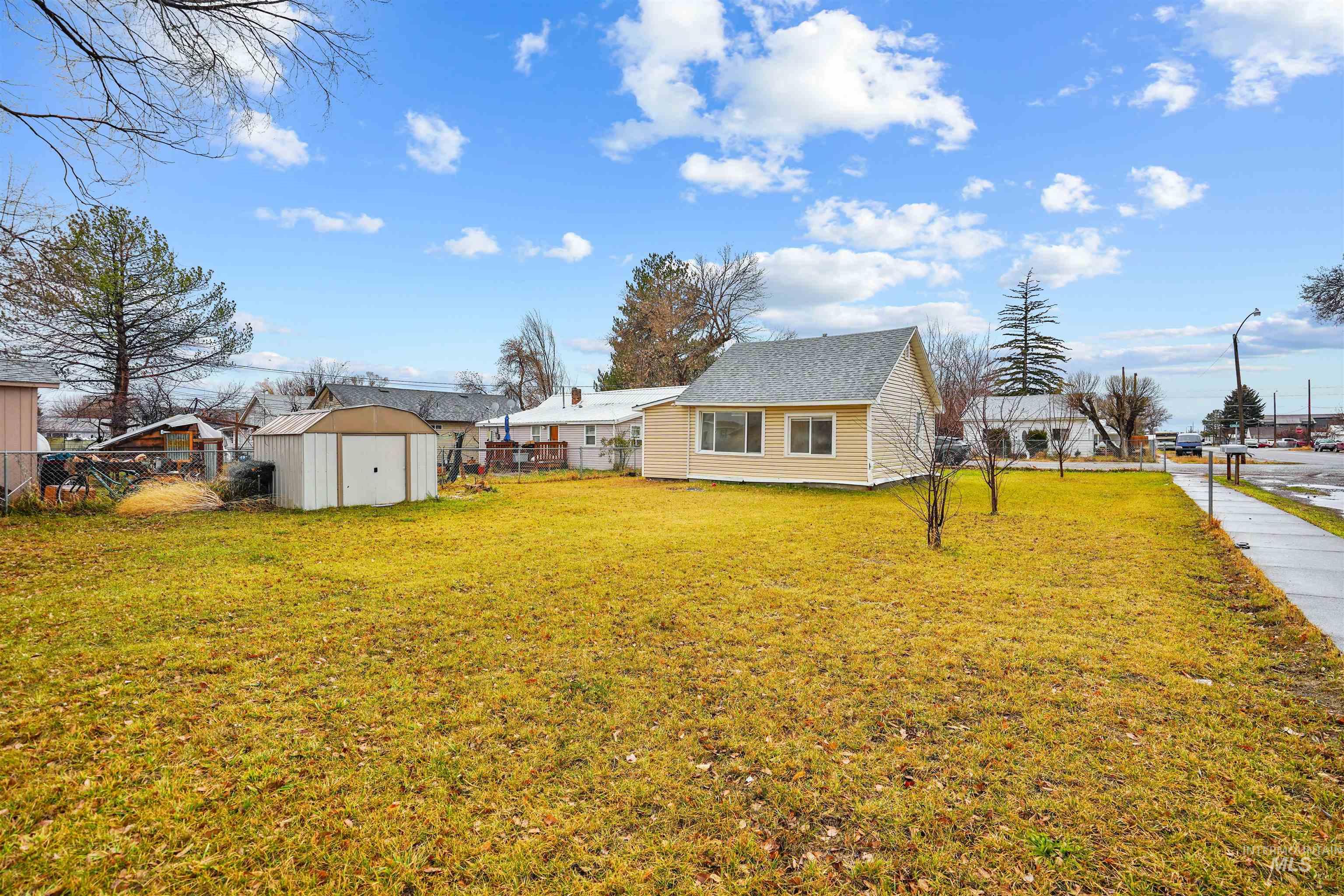 Fenced backyard with a storage shed