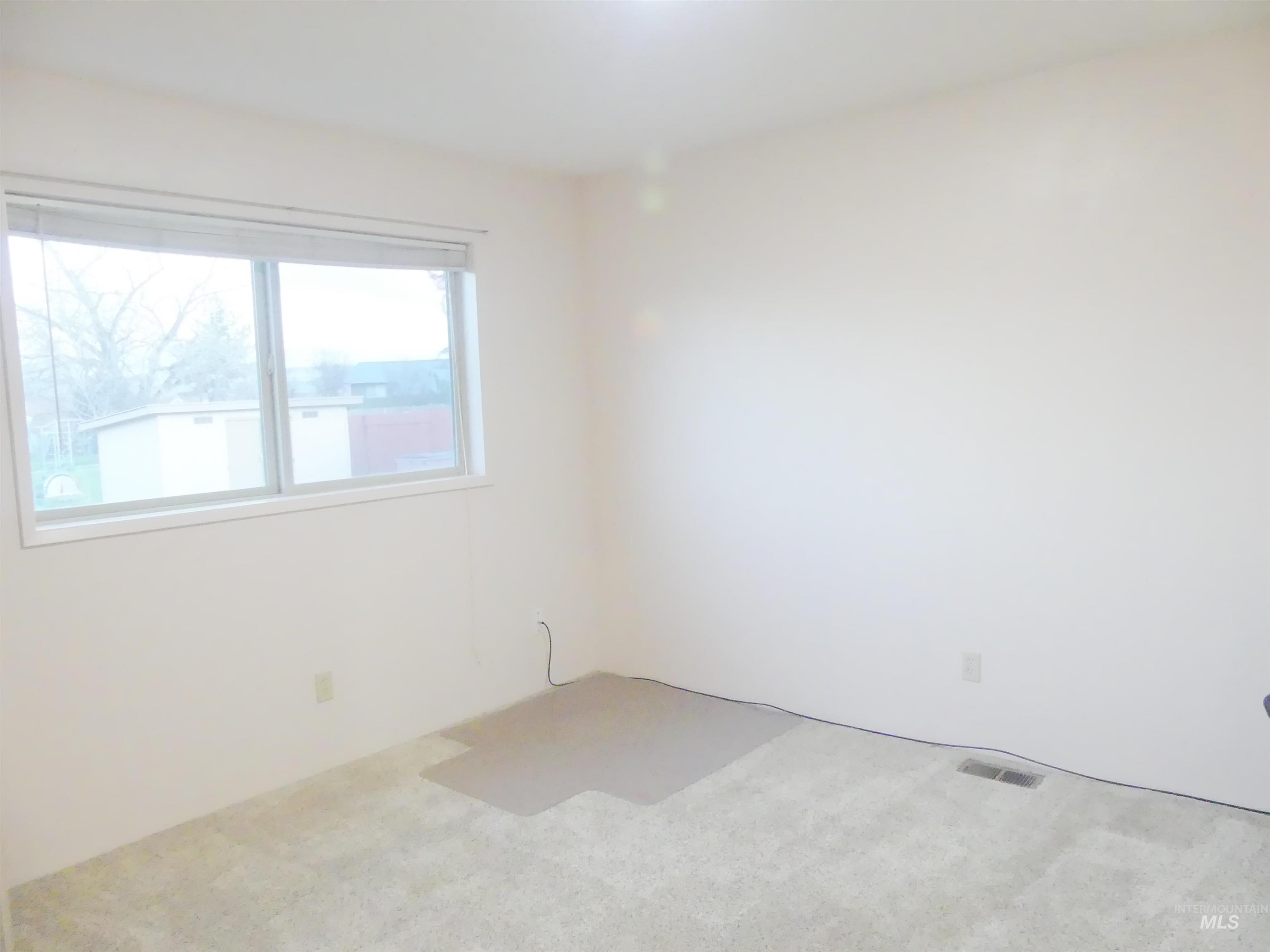 Spare room featuring carpet