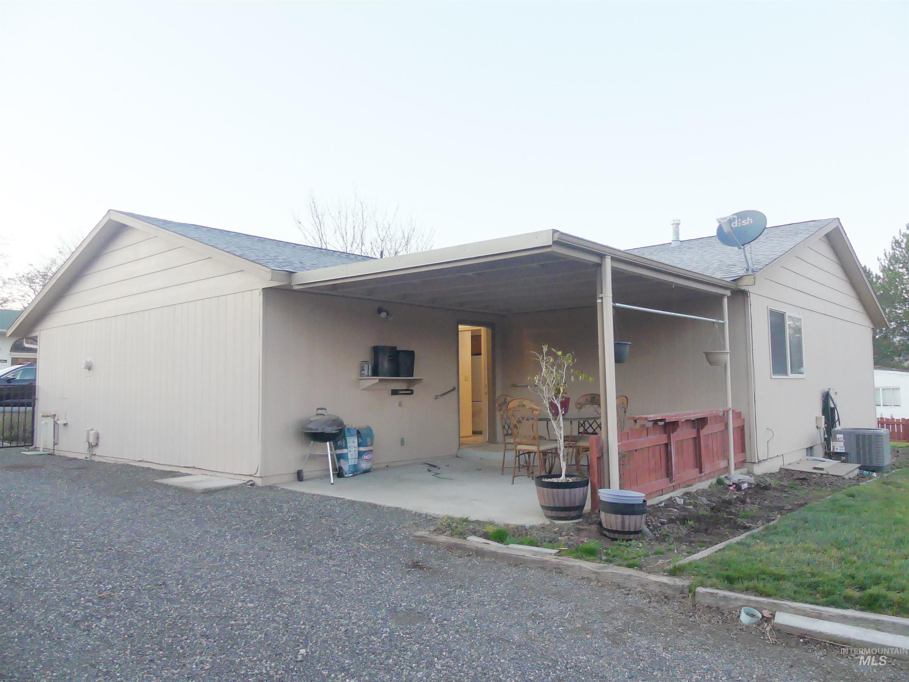 Rear view of property featuring a patio and a shingled roof