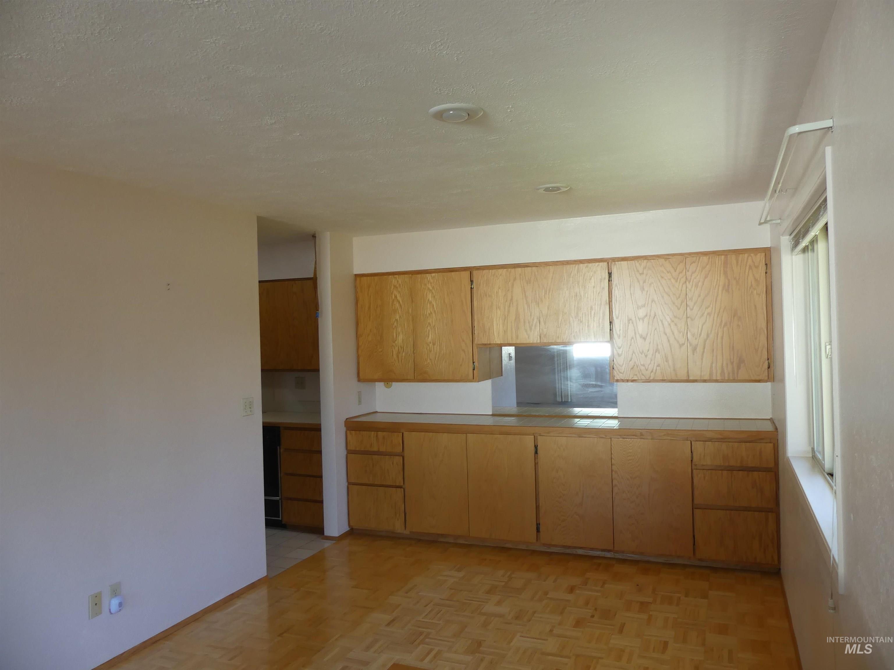 Kitchen featuring light countertops and a textured ceiling