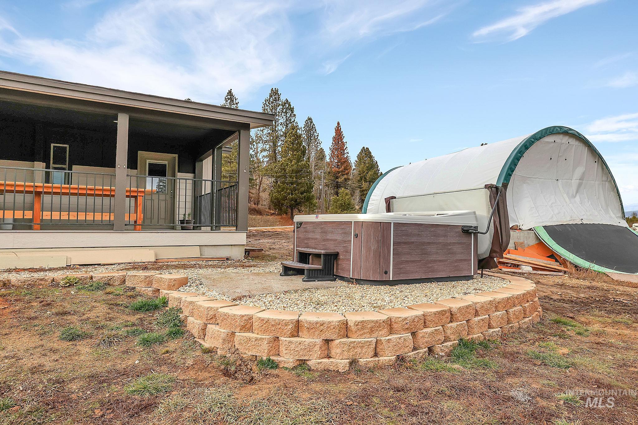 View of yard featuring a hot tub and covered porch