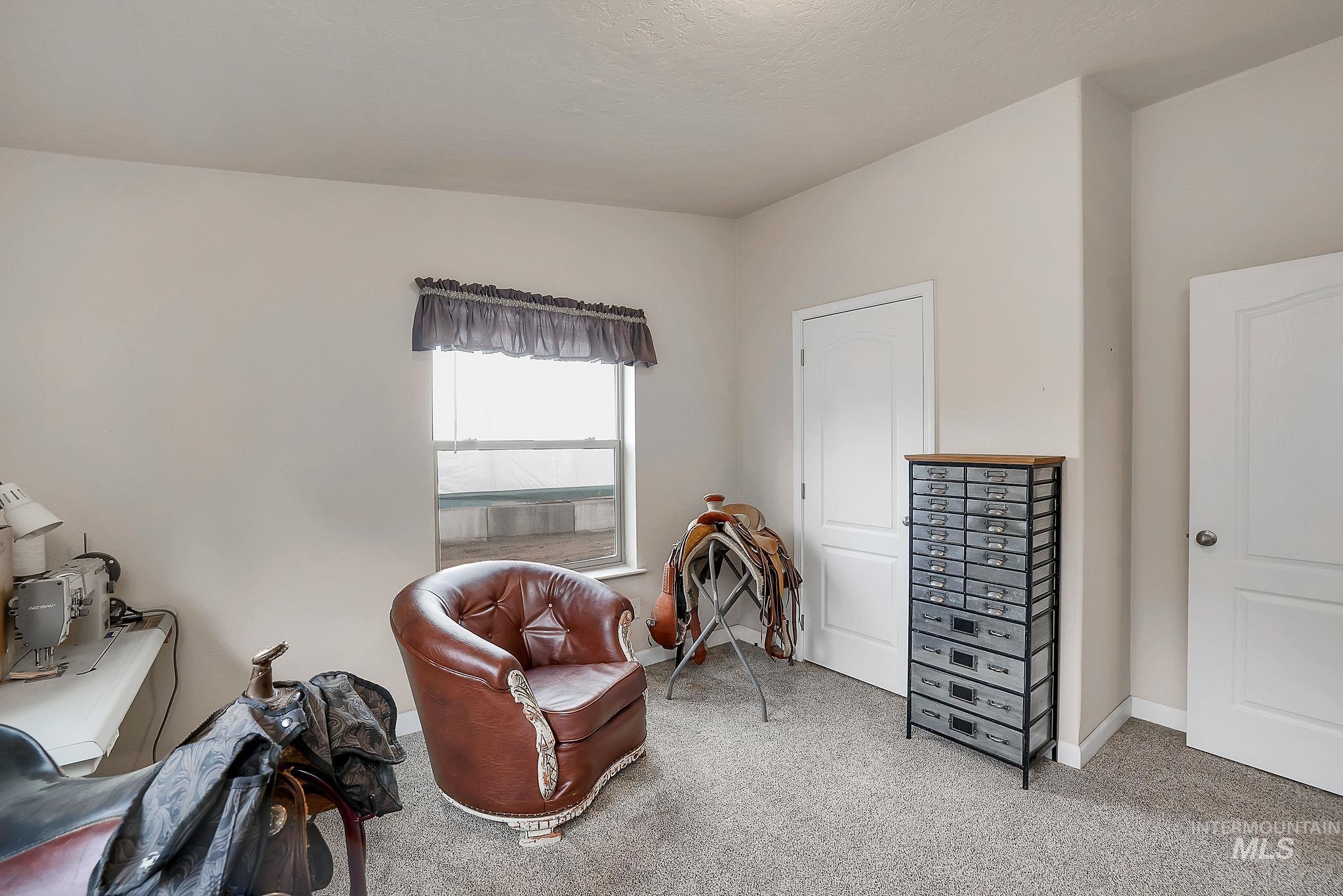 Living area with carpet flooring and baseboards