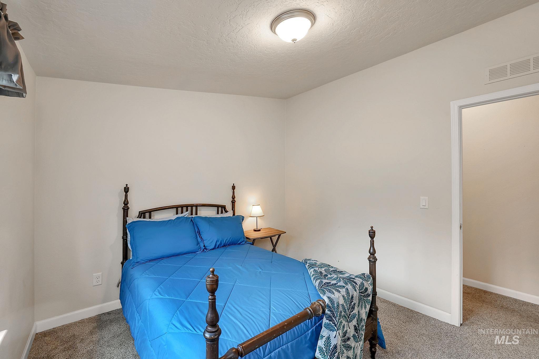 Bedroom with carpet flooring and a textured ceiling