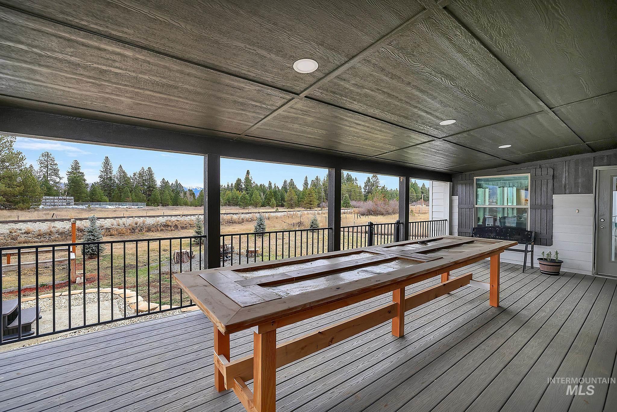 Deck featuring view of scattered trees