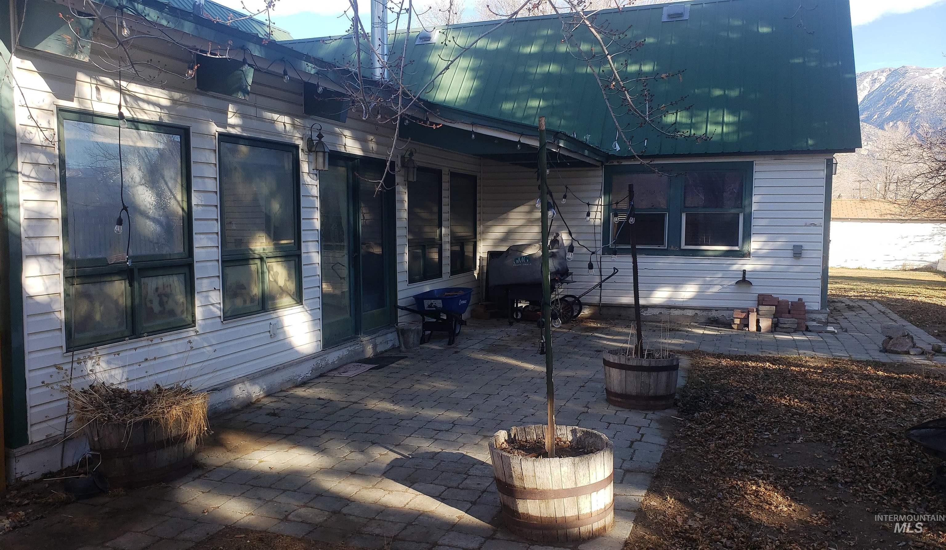 Rear view of property with a patio area and a metal roof
