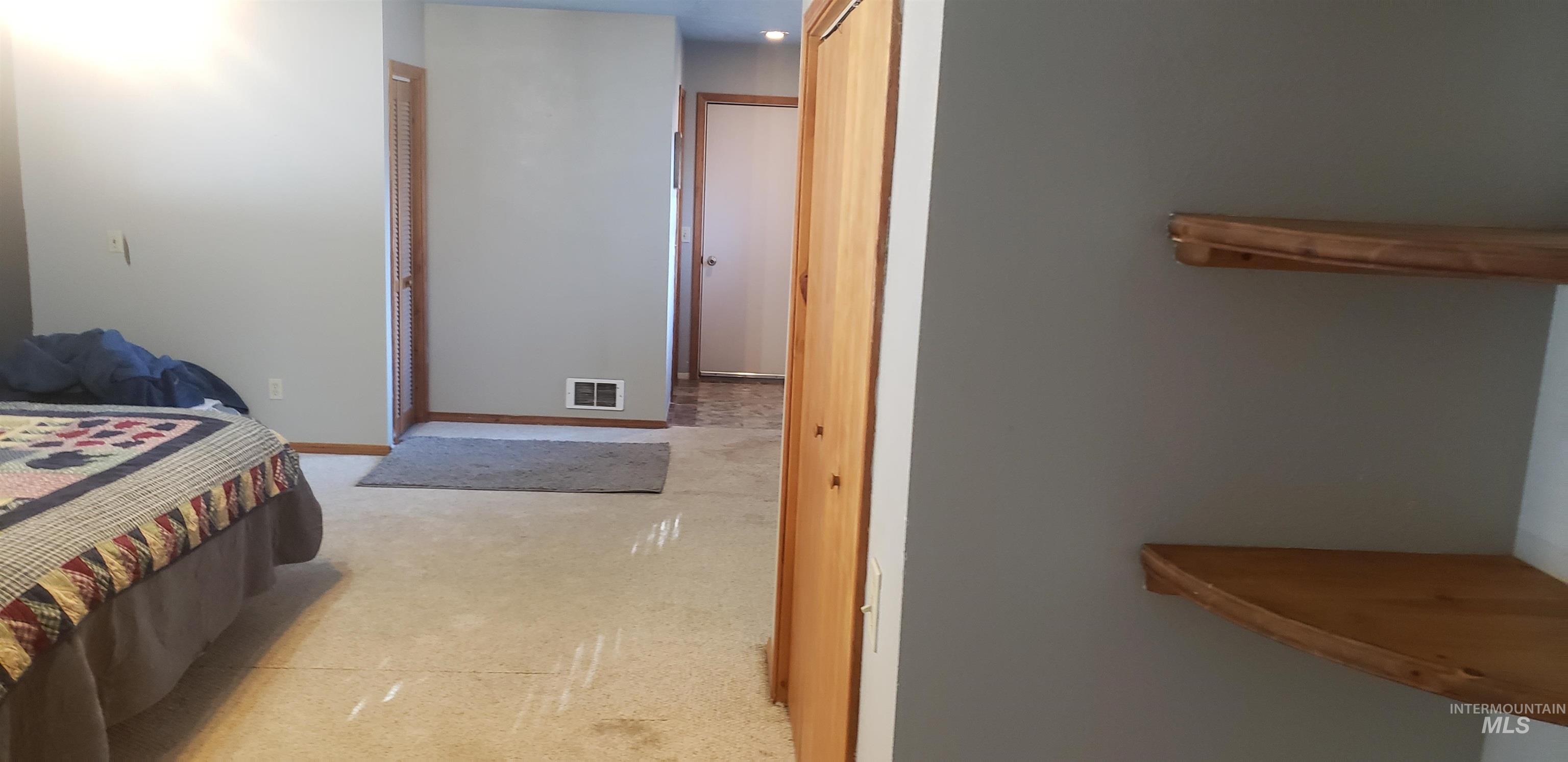 Bedroom with light colored carpet and recessed lighting