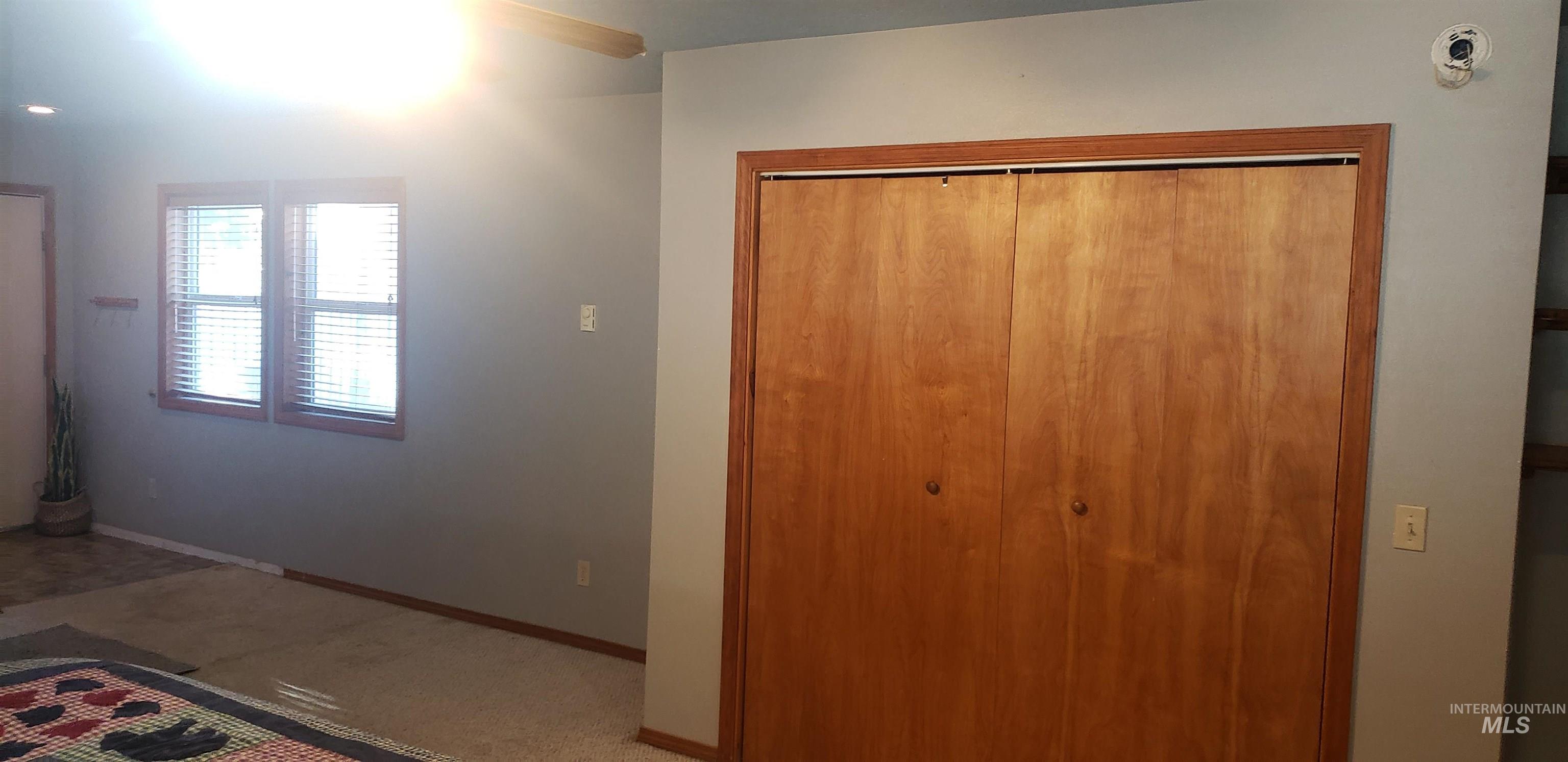Unfurnished bedroom with a closet, ceiling fan, and carpet flooring