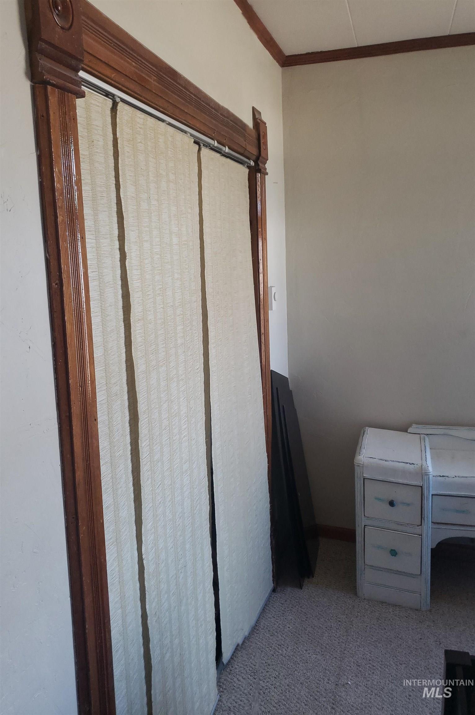Interior space featuring carpet floors and crown molding