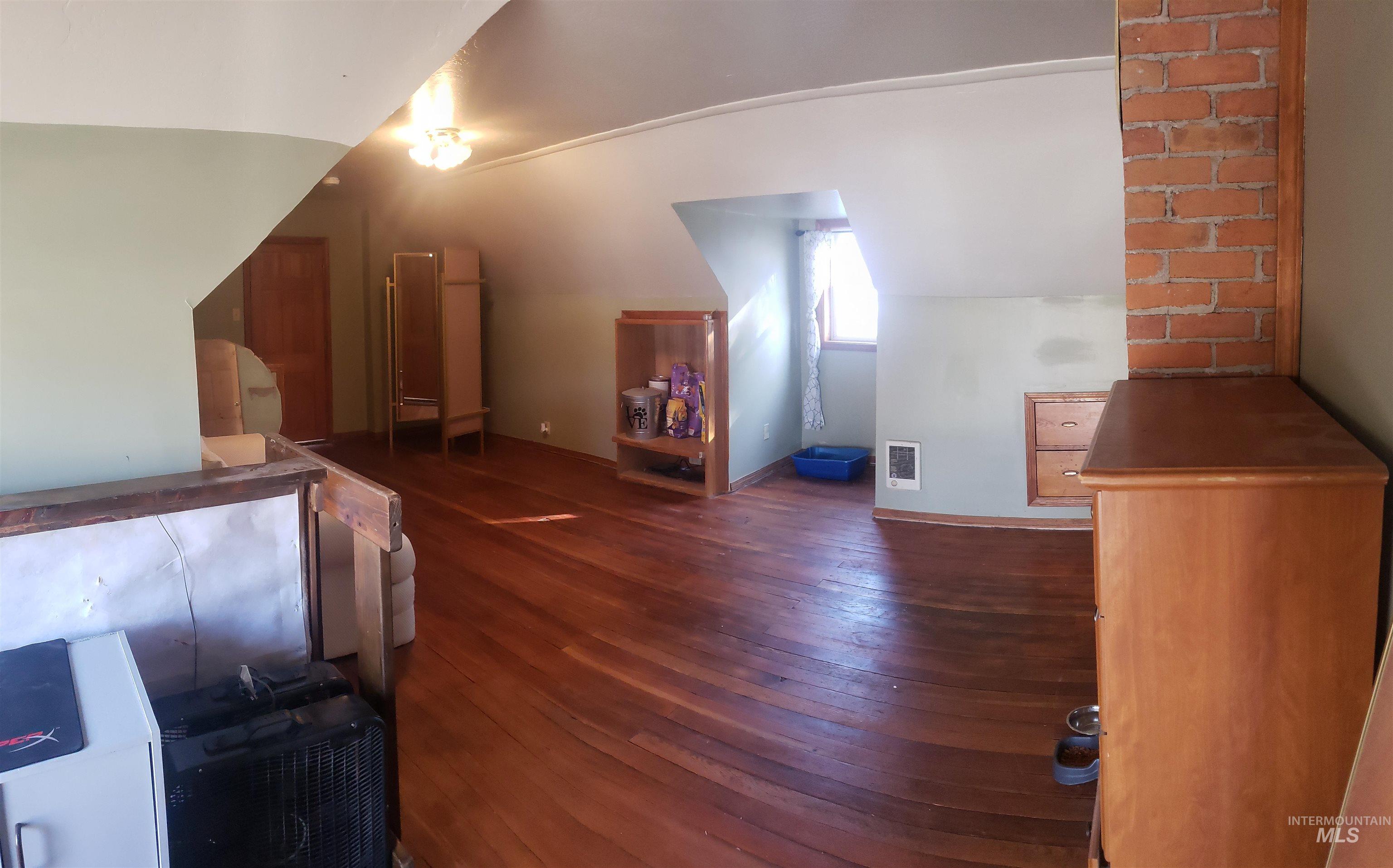 Bonus room featuring dark wood finished floors and baseboards