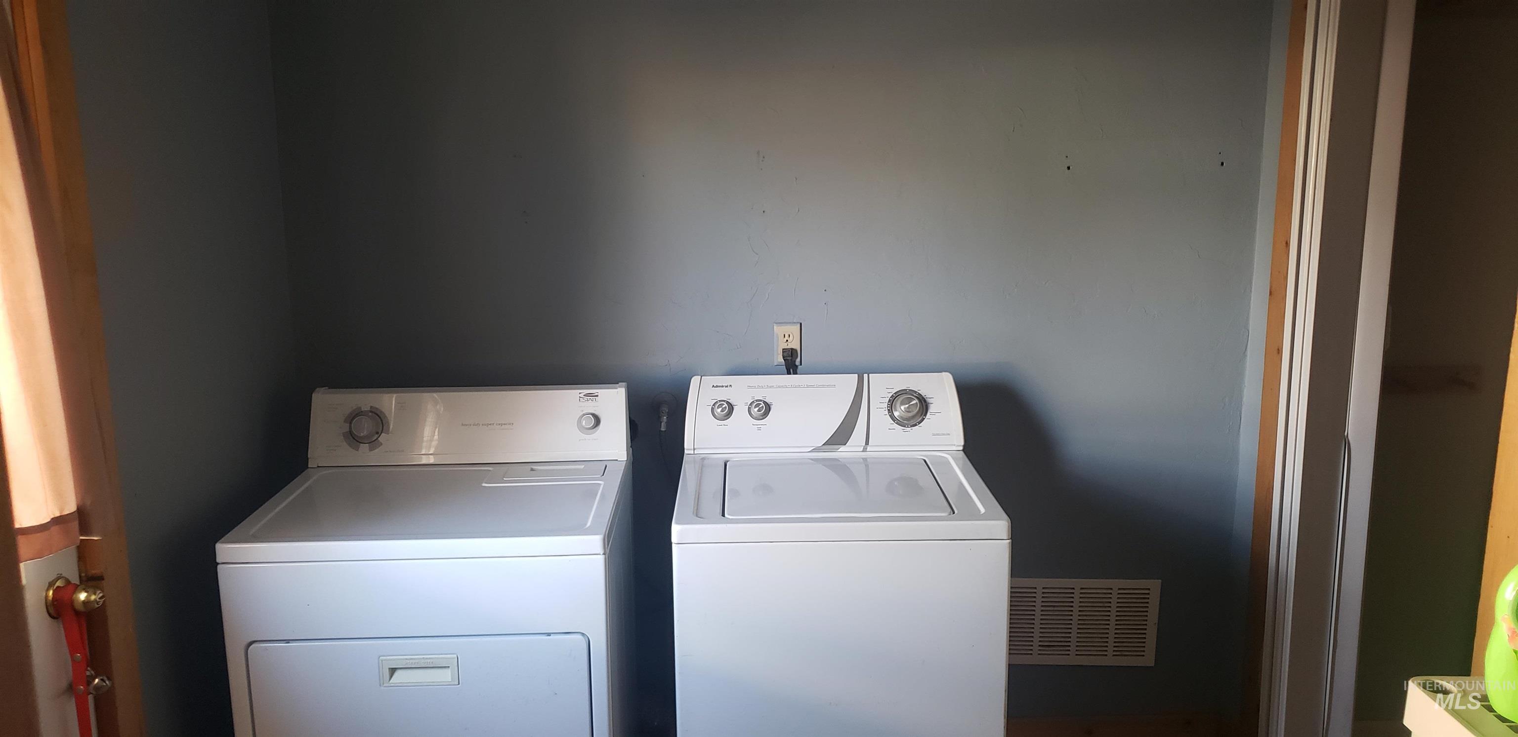 Washroom with washer and clothes dryer