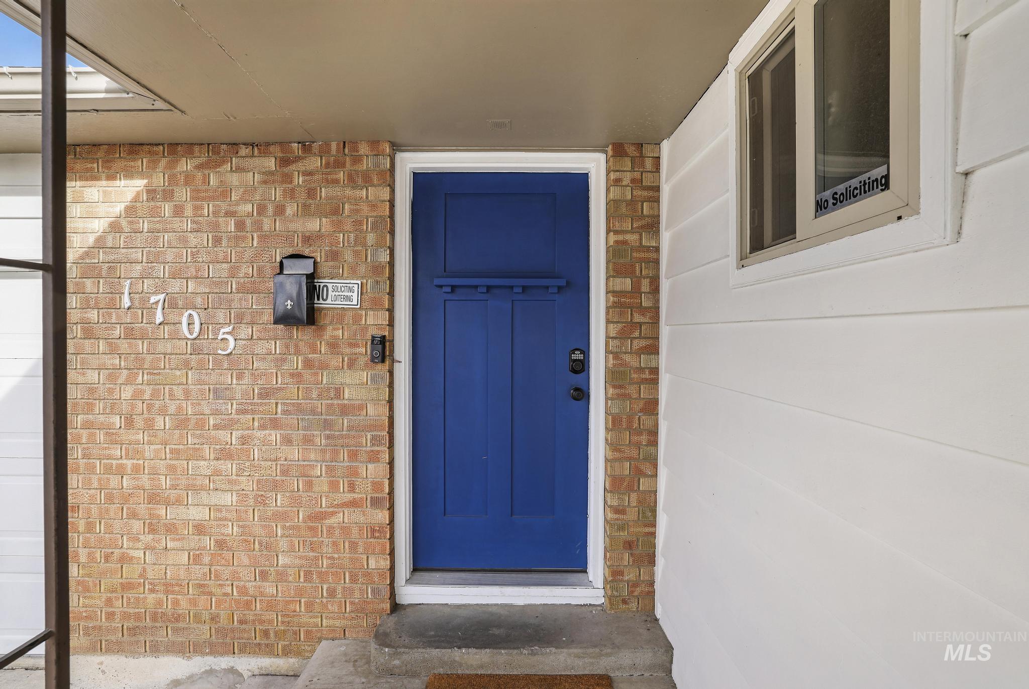 Doorway to property with brick siding