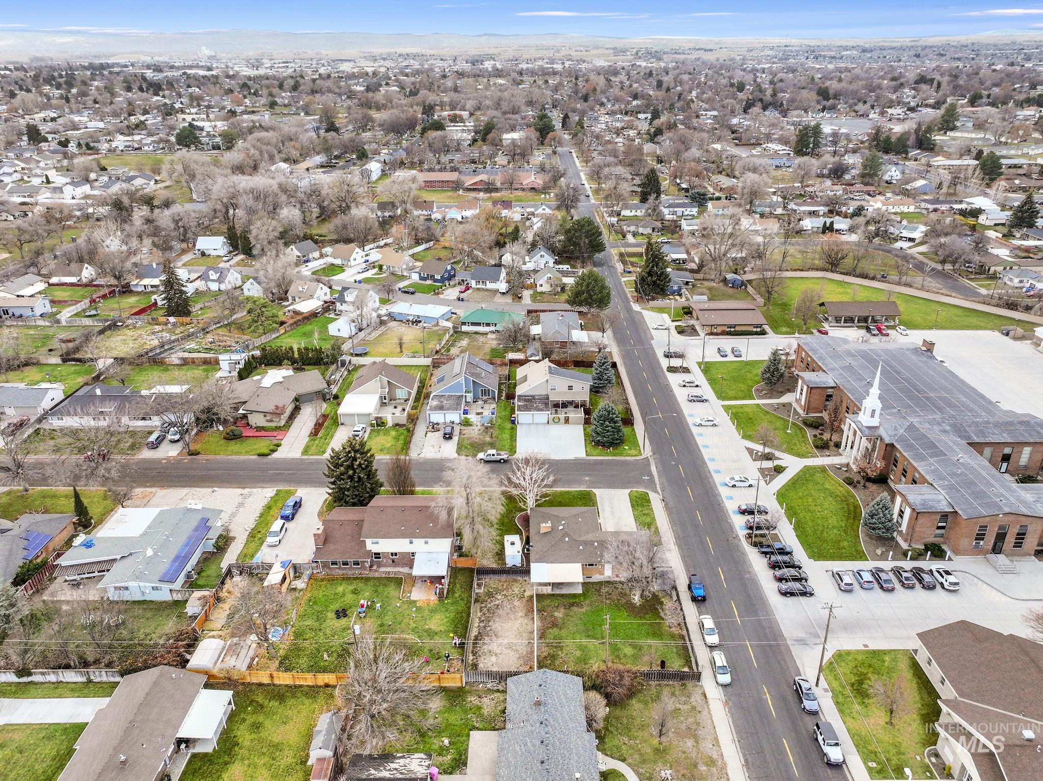Aerial view of property's location with nearby suburban area
