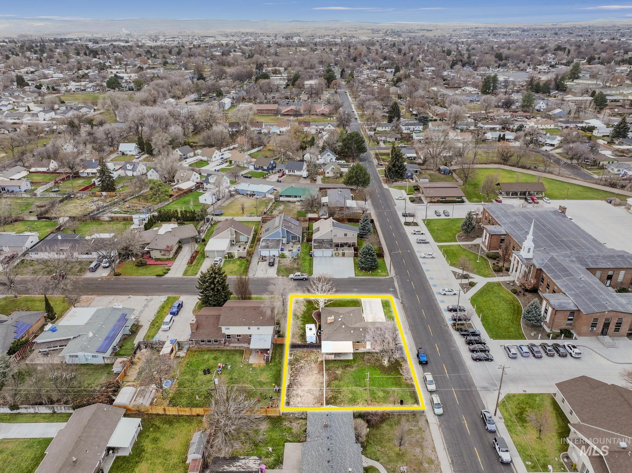 Aerial perspective of suburban area featuring property boundaries highlighted