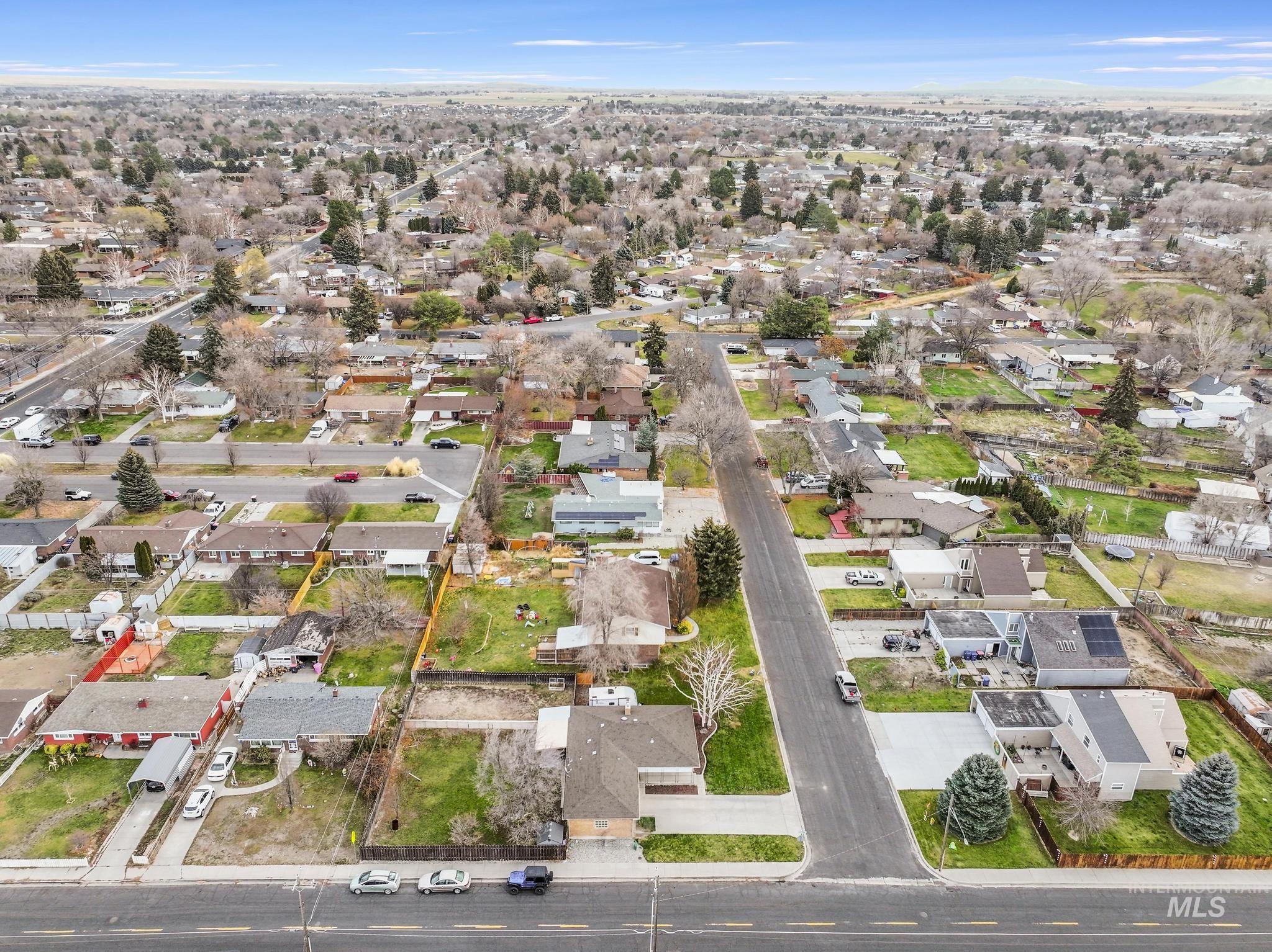 Aerial view of property's location featuring nearby suburban area