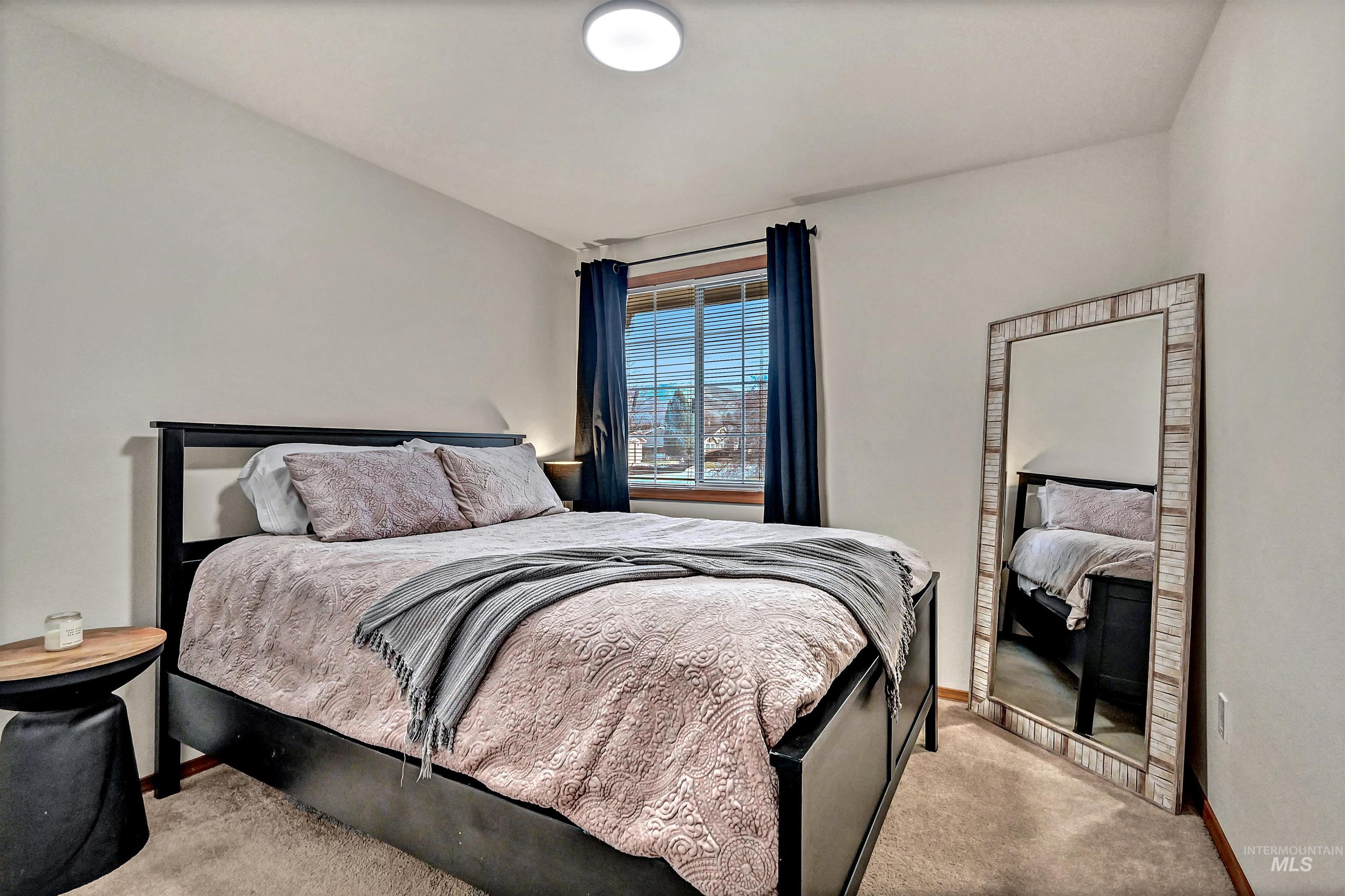 Bedroom with carpet floors and baseboards