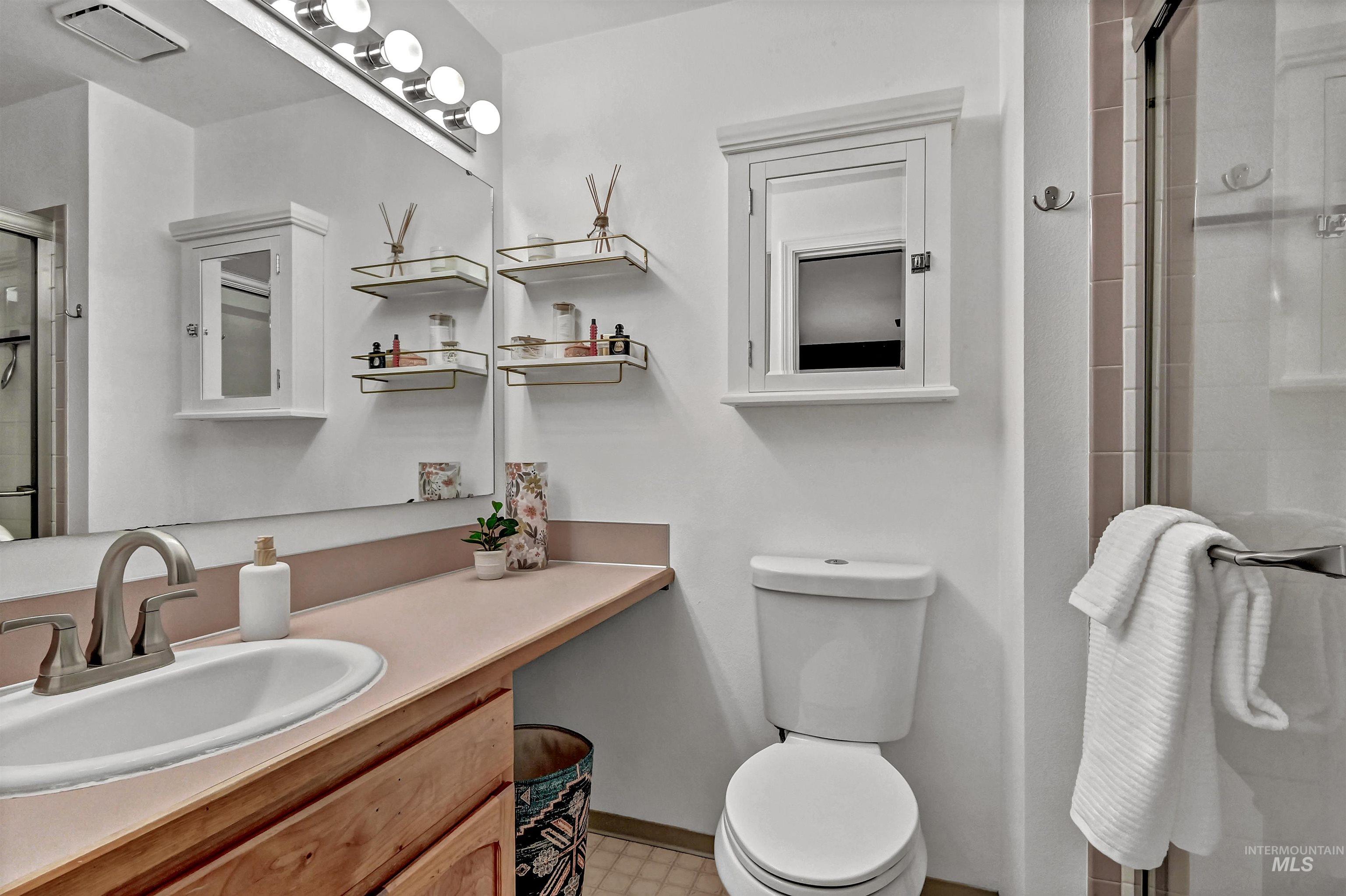 Bathroom featuring a shower stall and vanity