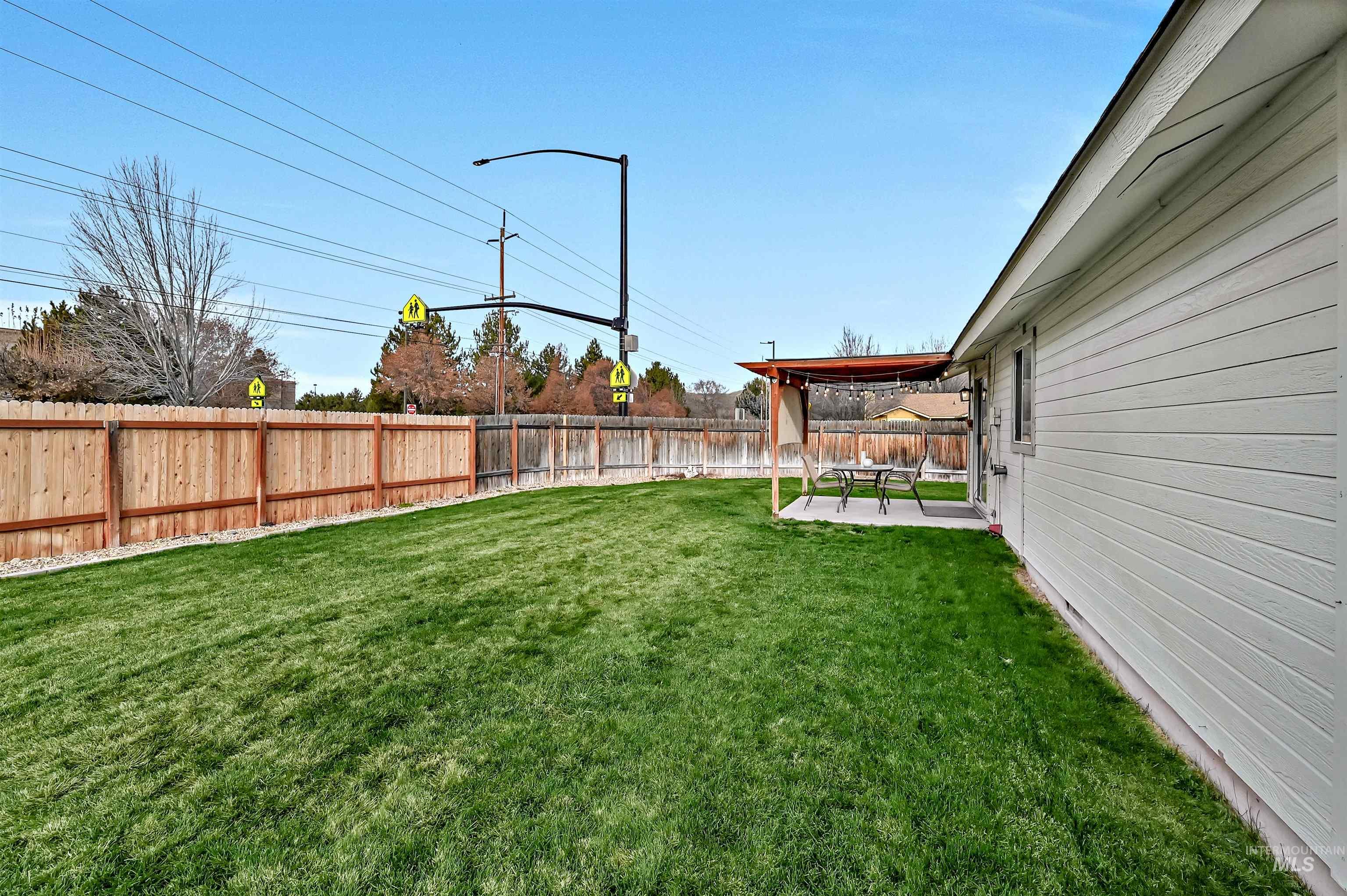 Fenced backyard featuring a patio