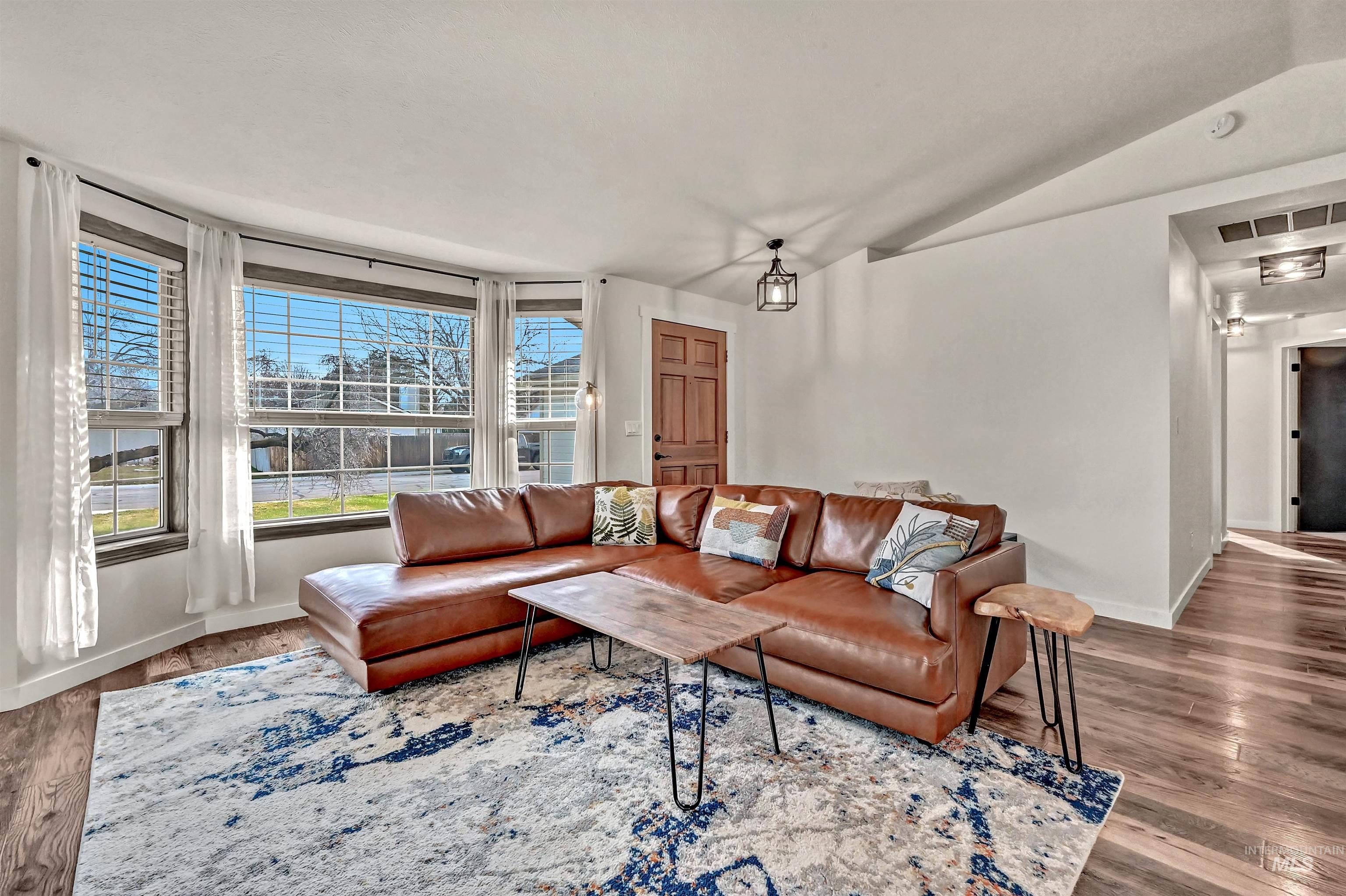 Living room with lofted ceiling and wood finished floors