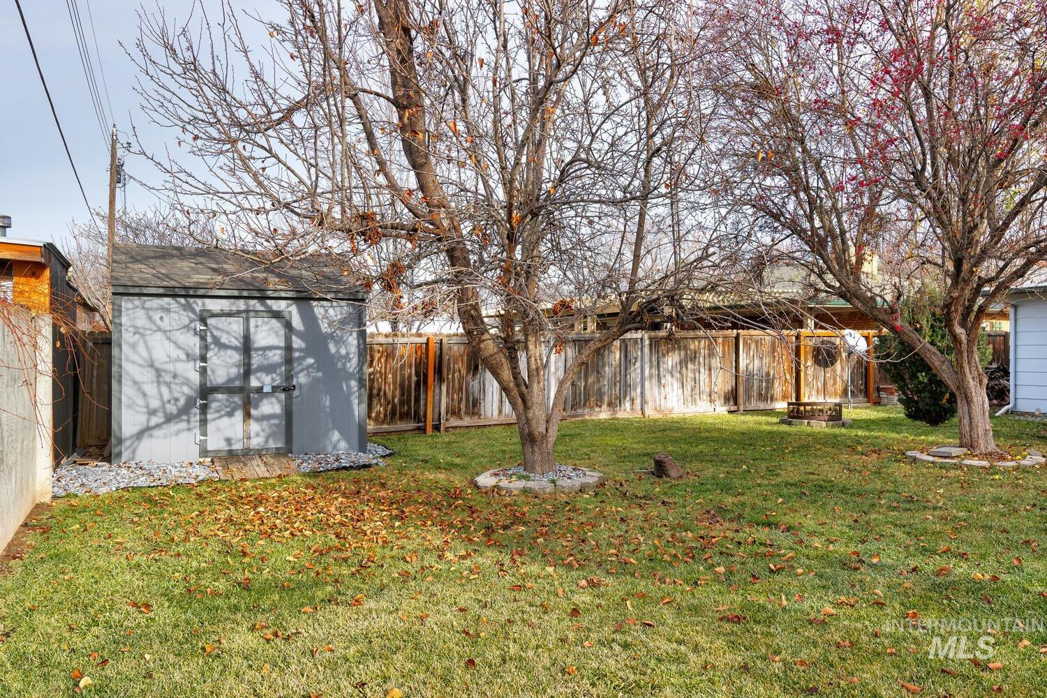 Fenced backyard with a storage shed