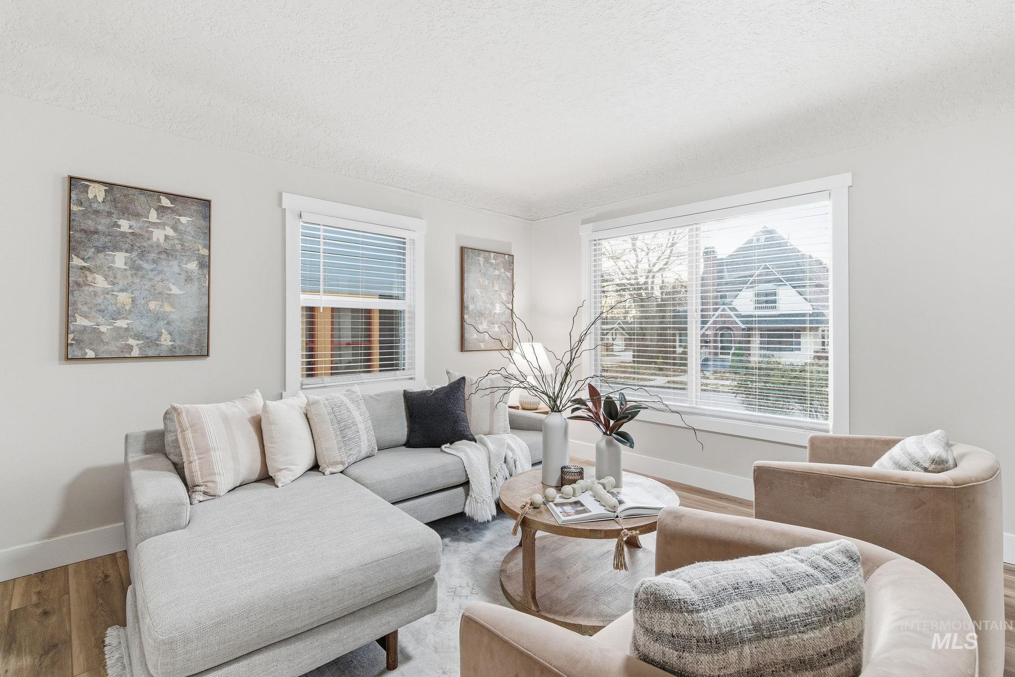 Living room with wood finished floors and a textured ceiling