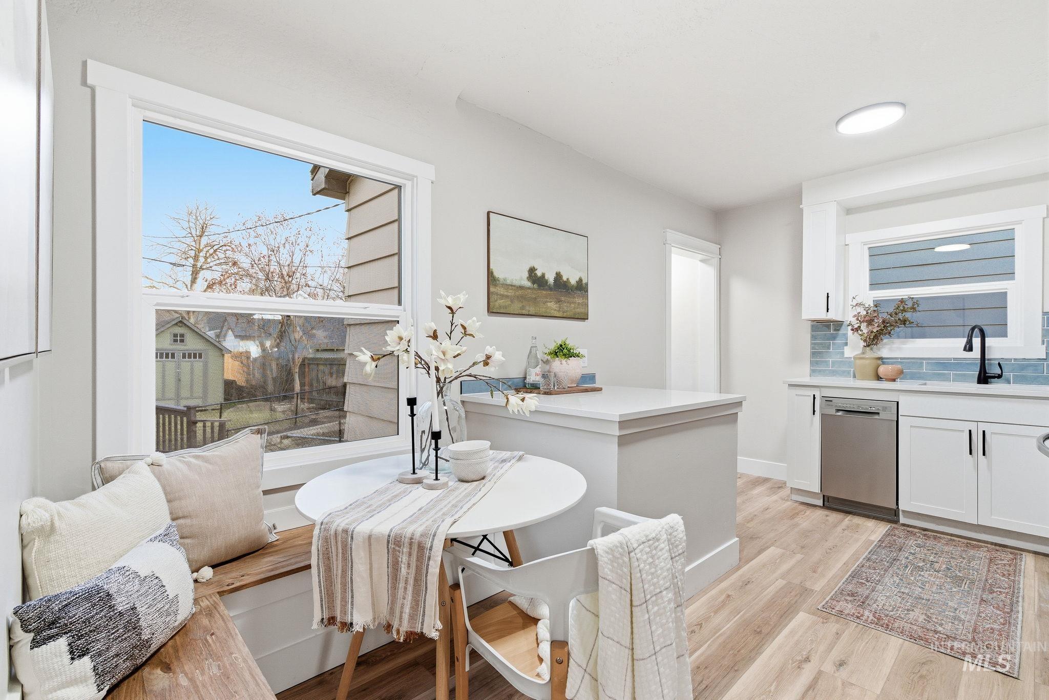 Dining space with light wood finished floors and plenty of natural light