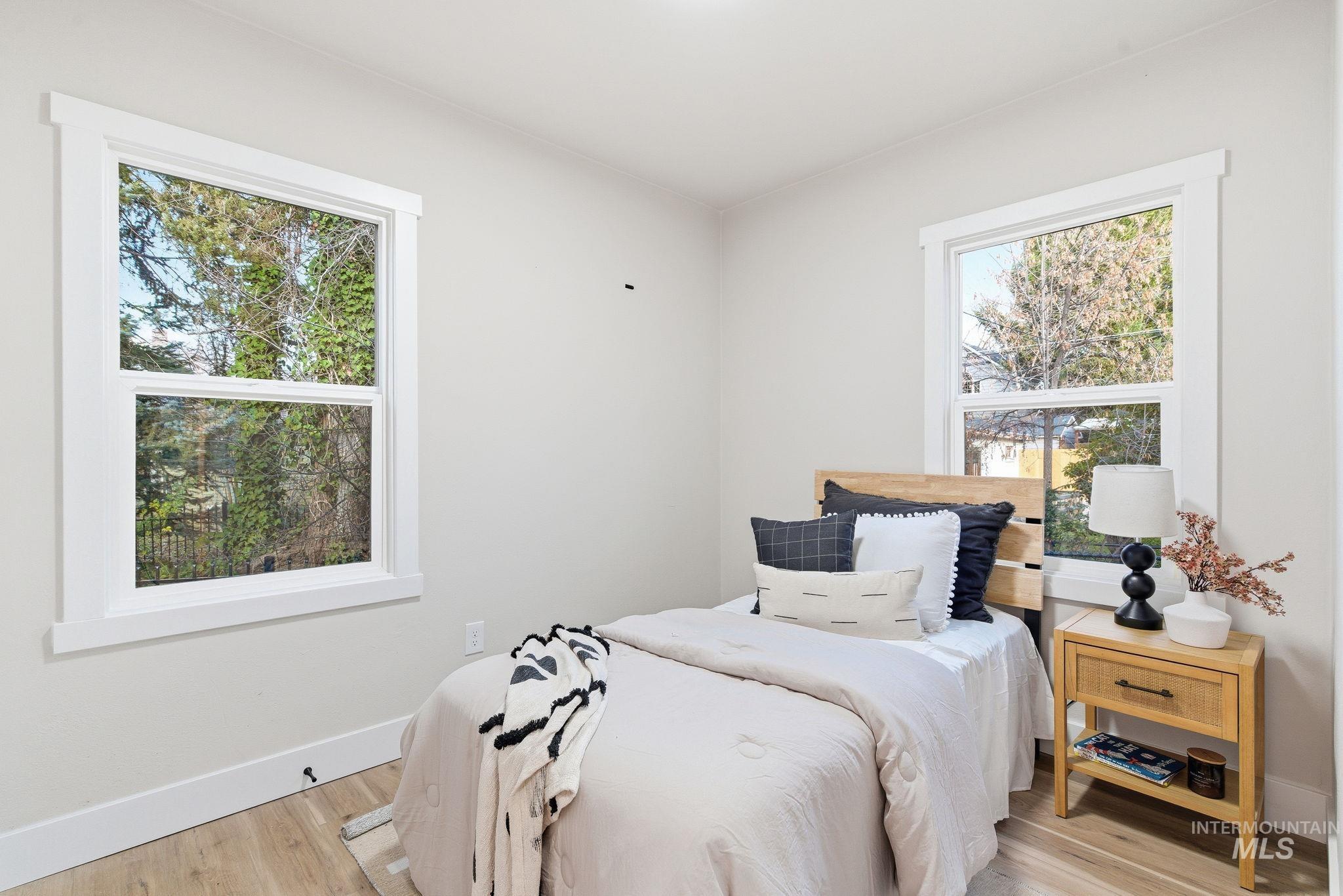 Bedroom with light wood-style flooring and baseboards