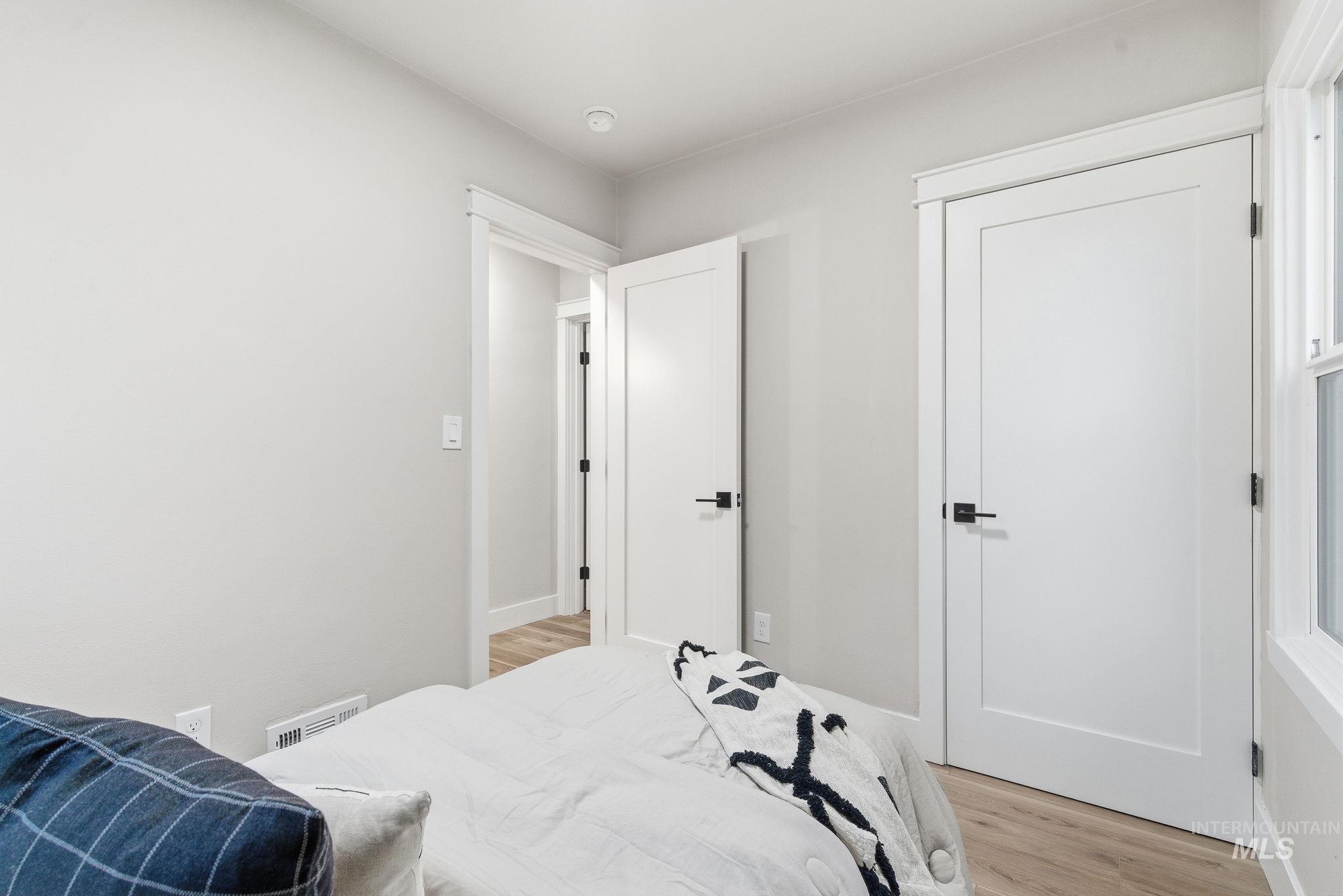 Bedroom with light wood-type flooring and baseboards