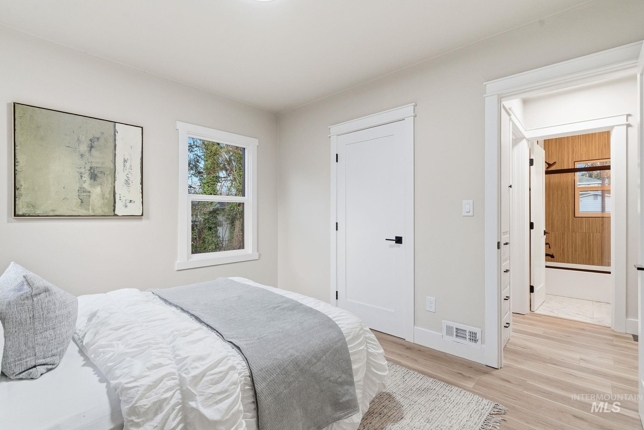 Bedroom featuring light wood finished floors and baseboards