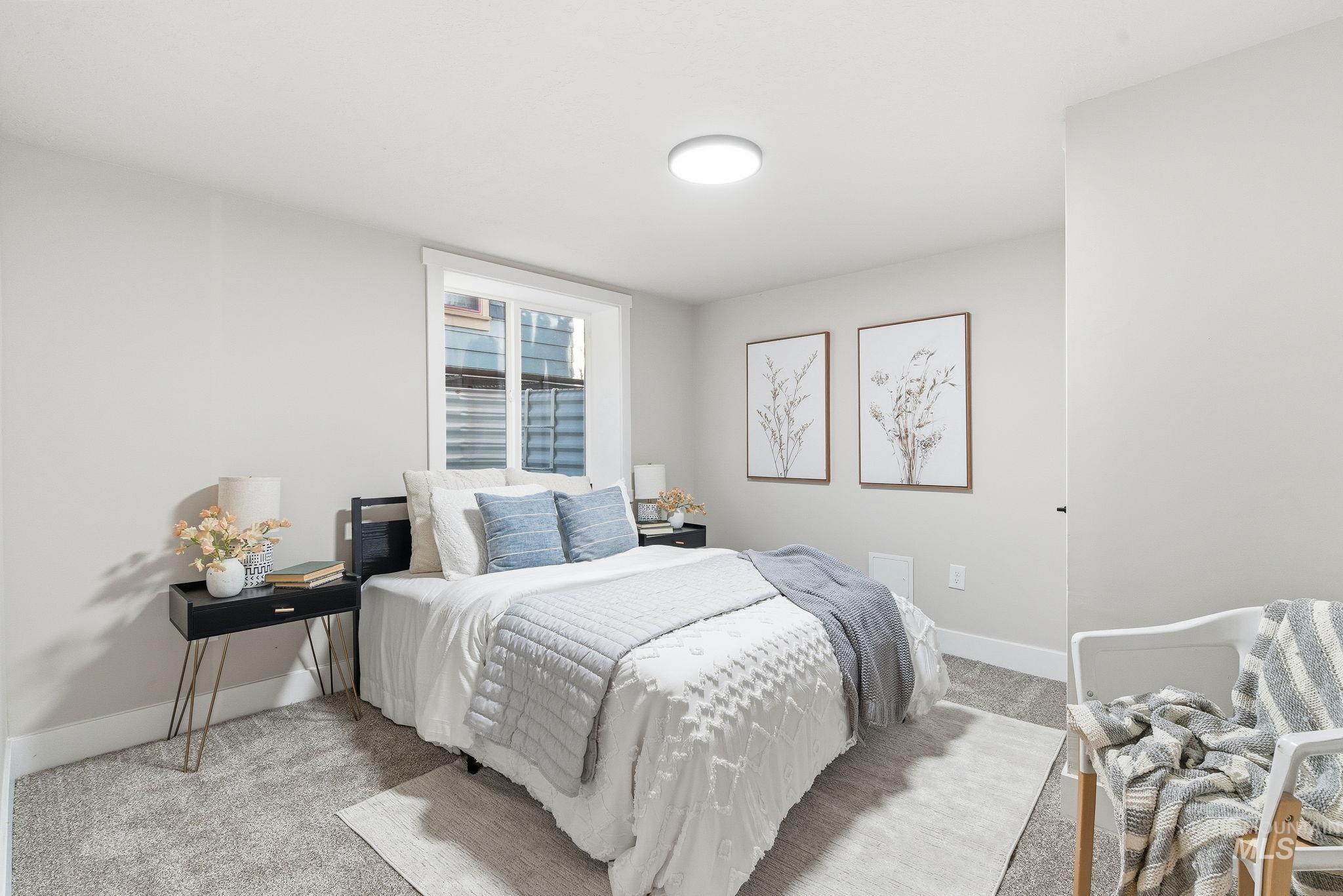Carpeted bedroom featuring baseboards