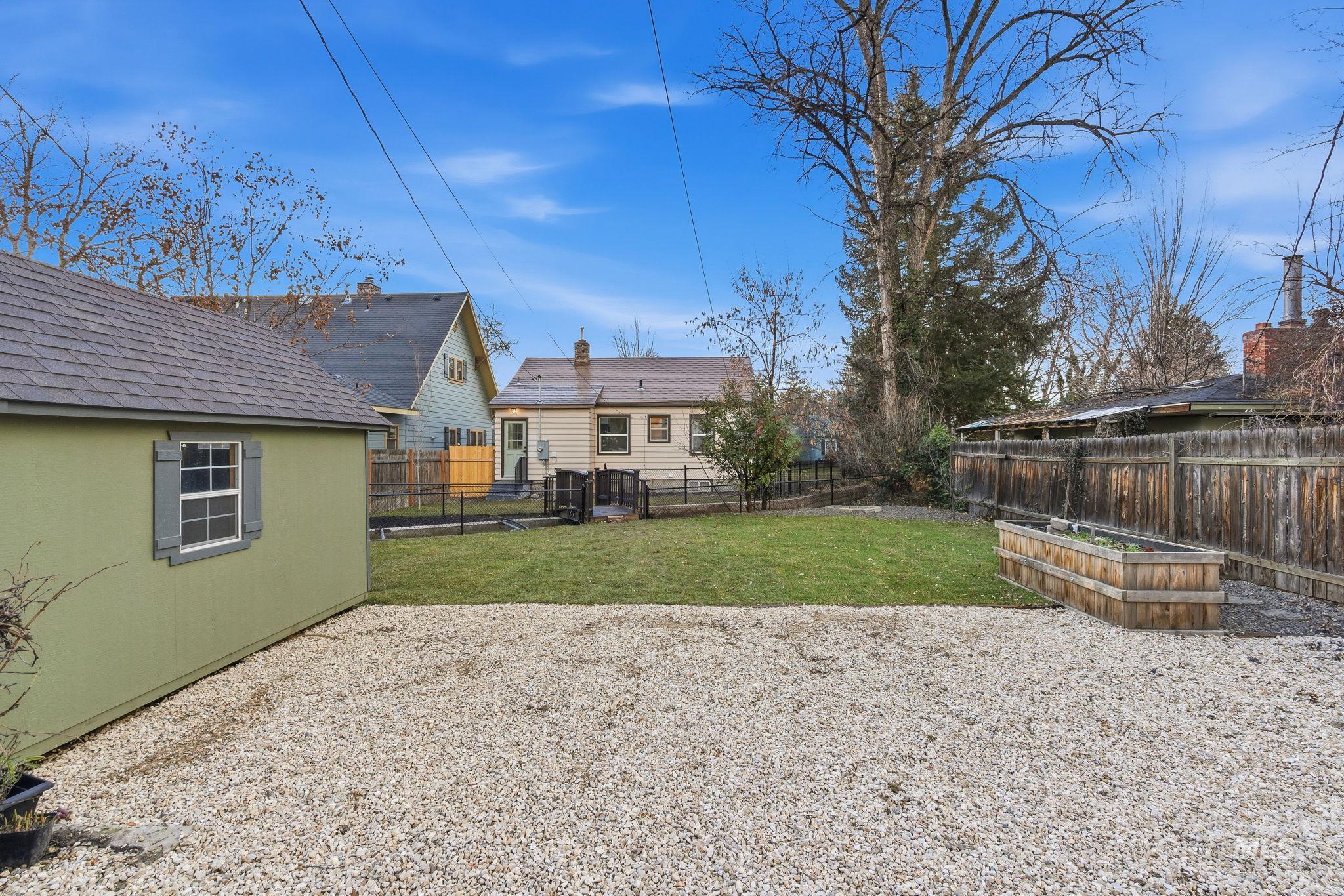 Fenced backyard featuring a vegetable garden