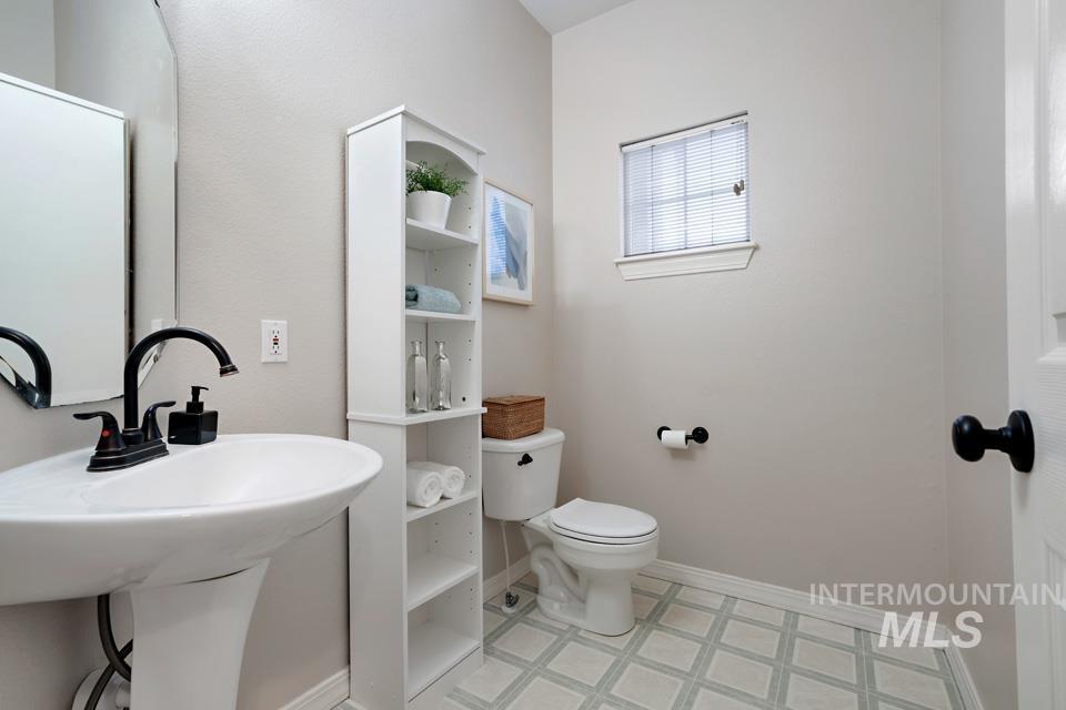 Bathroom featuring toilet and light floors