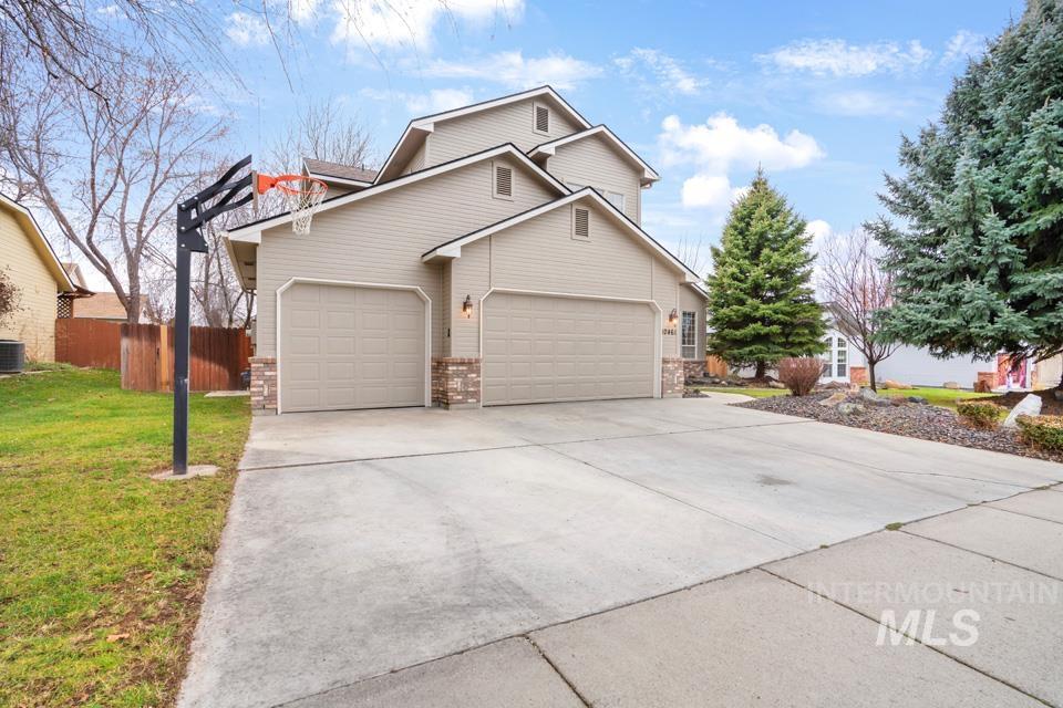 Traditional-style home with concrete driveway and an attached garage
